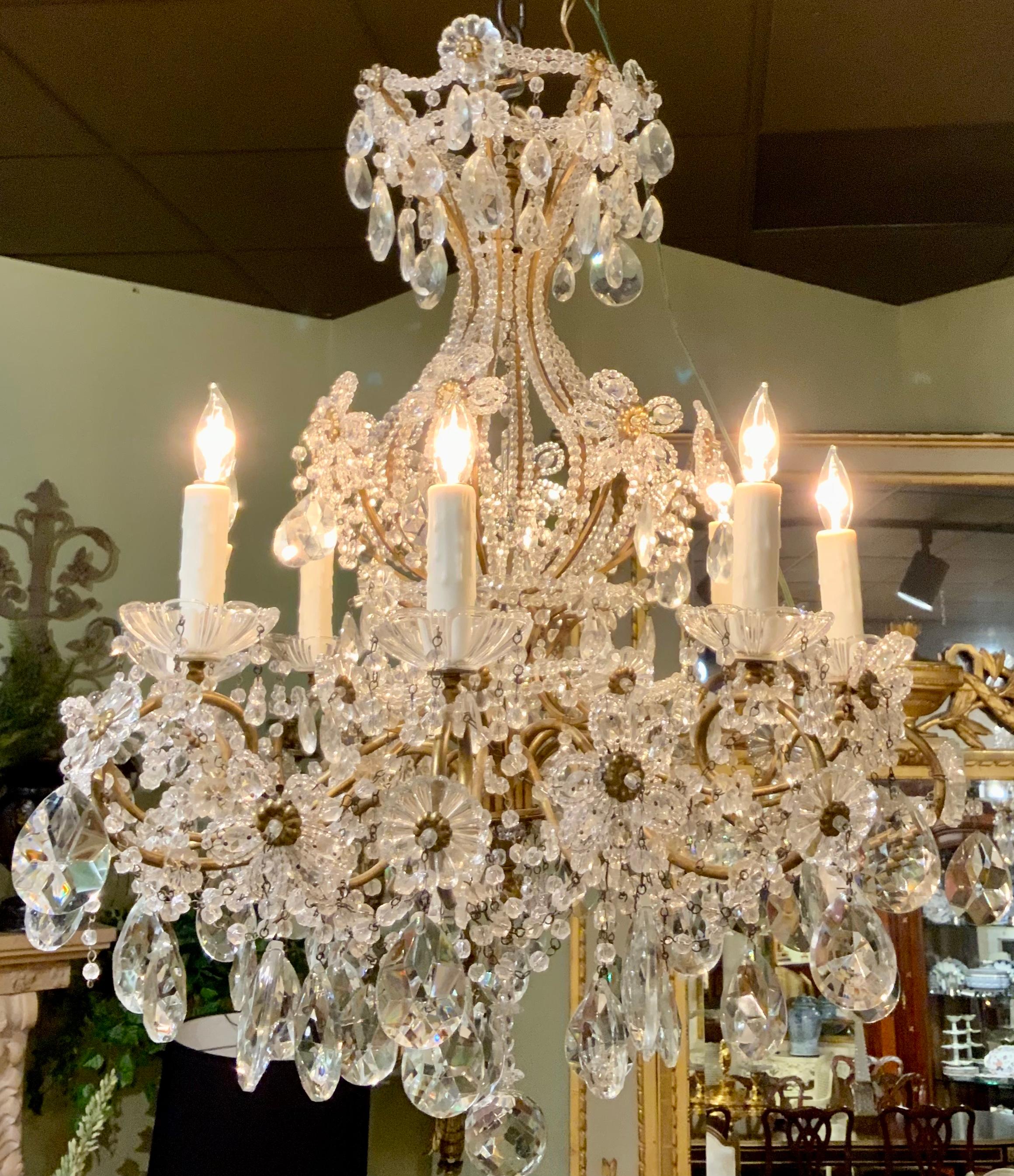 This eight light chandelier is in very good condition with good wiring
And clear crystal. The brass frame is gilt with the original bright patina.
It has a vasiform frame with glass beading, supporting eight scrolled
Candle arms set with molded