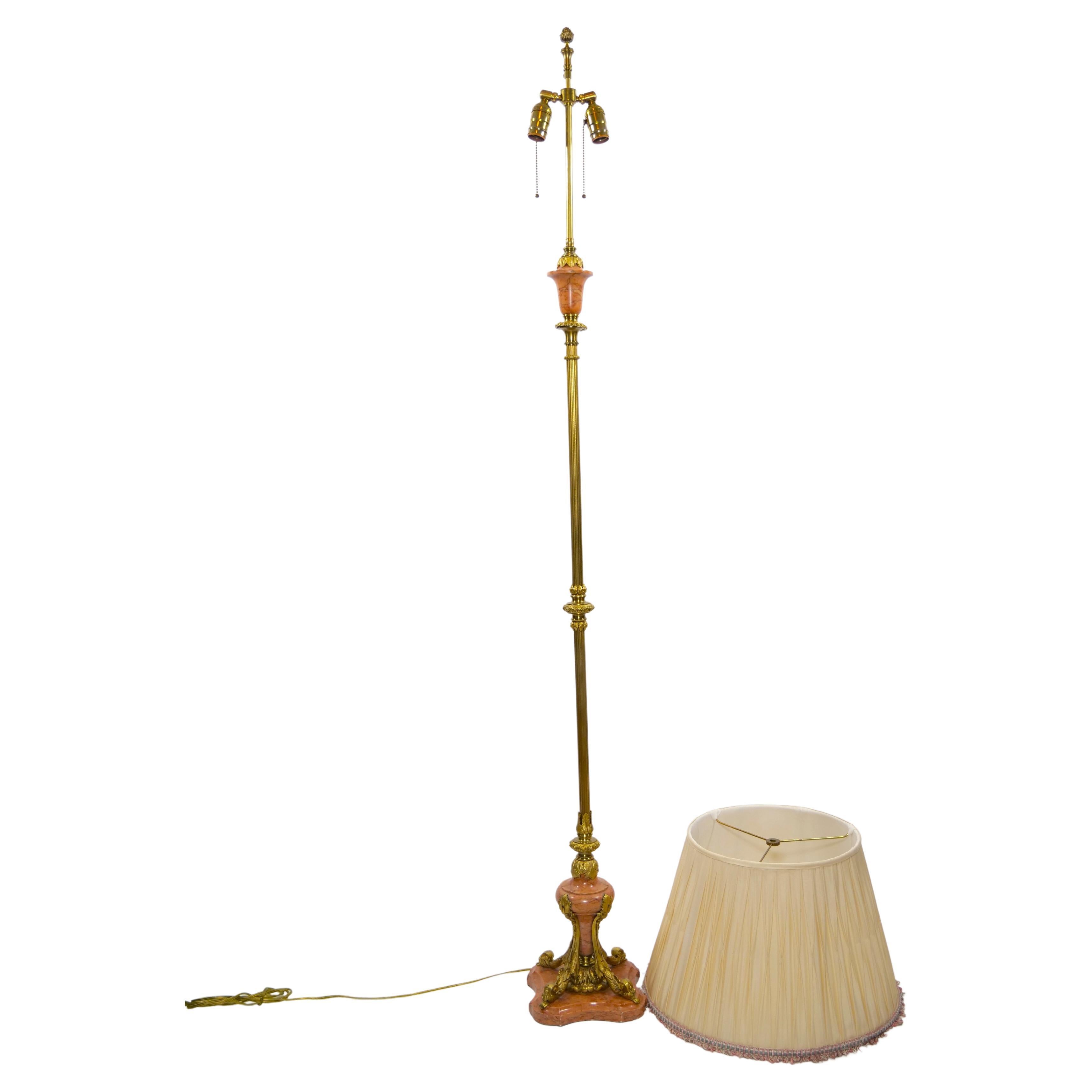 Late 19th century hand crafted gilt brass with marble base Italian floor lamp. The floor lamp features a very slender shape with design details resting on a square marble base. The lamp comes with a silk pleated interior shade. It is in great