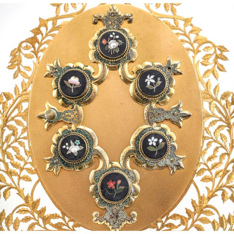Italian Gilt Bronze and Pietra Dura Accent 3 Photo Frame, Mid-19th Century

Italian gilt bronze and Pietra Dura accent 3 photo frames from the Mid-19th Century. Six miniature inlaid hard-stone floral accents to the front of the frame. Hand-chased
