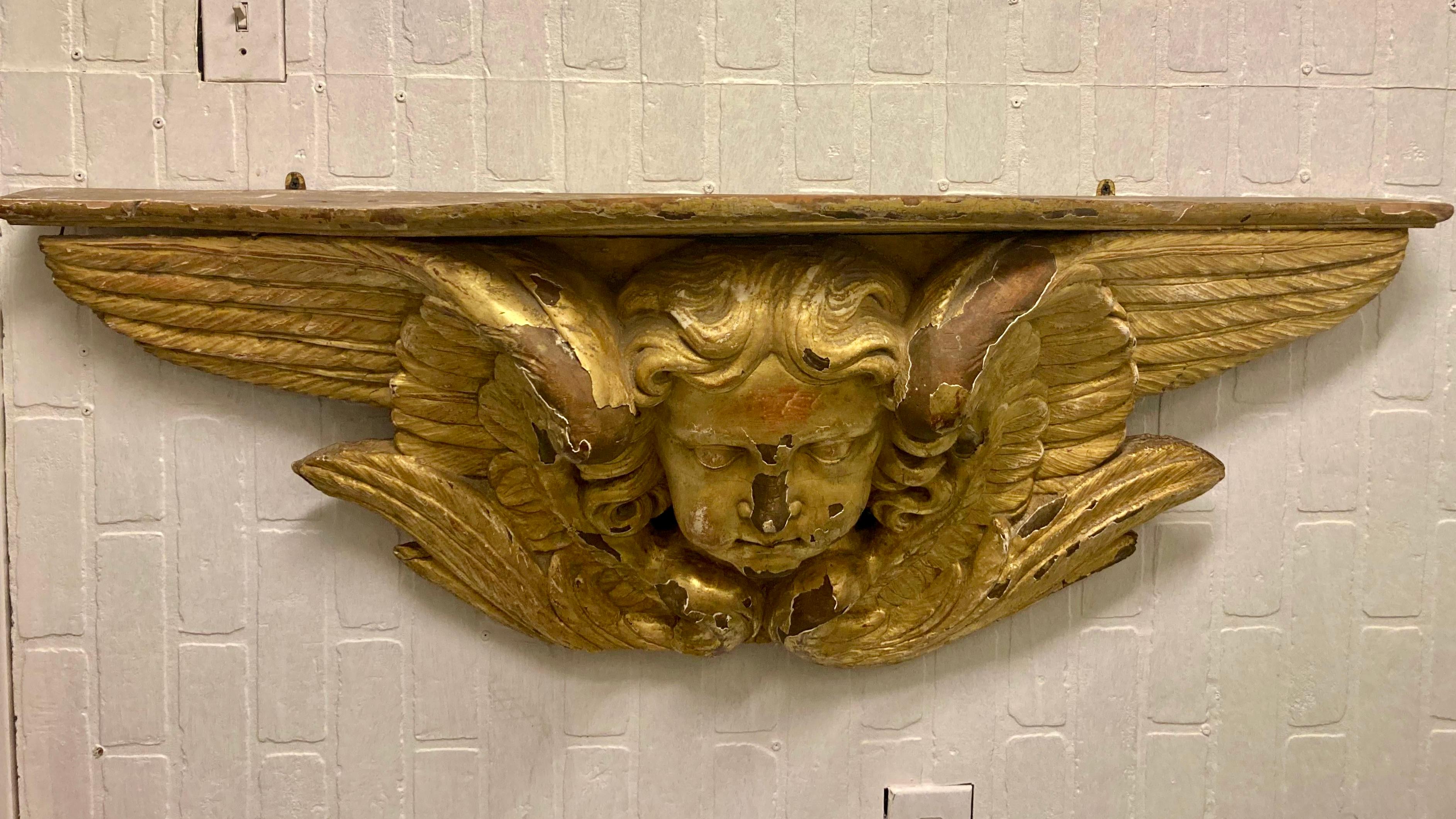 Gorgeous 17th Century gilt carved wood angel wall mounted console. Incredible carving details on this ancient wall mounted gilt wood console. The face details, the wing details, and the surface details are very well organized and mounts easily to