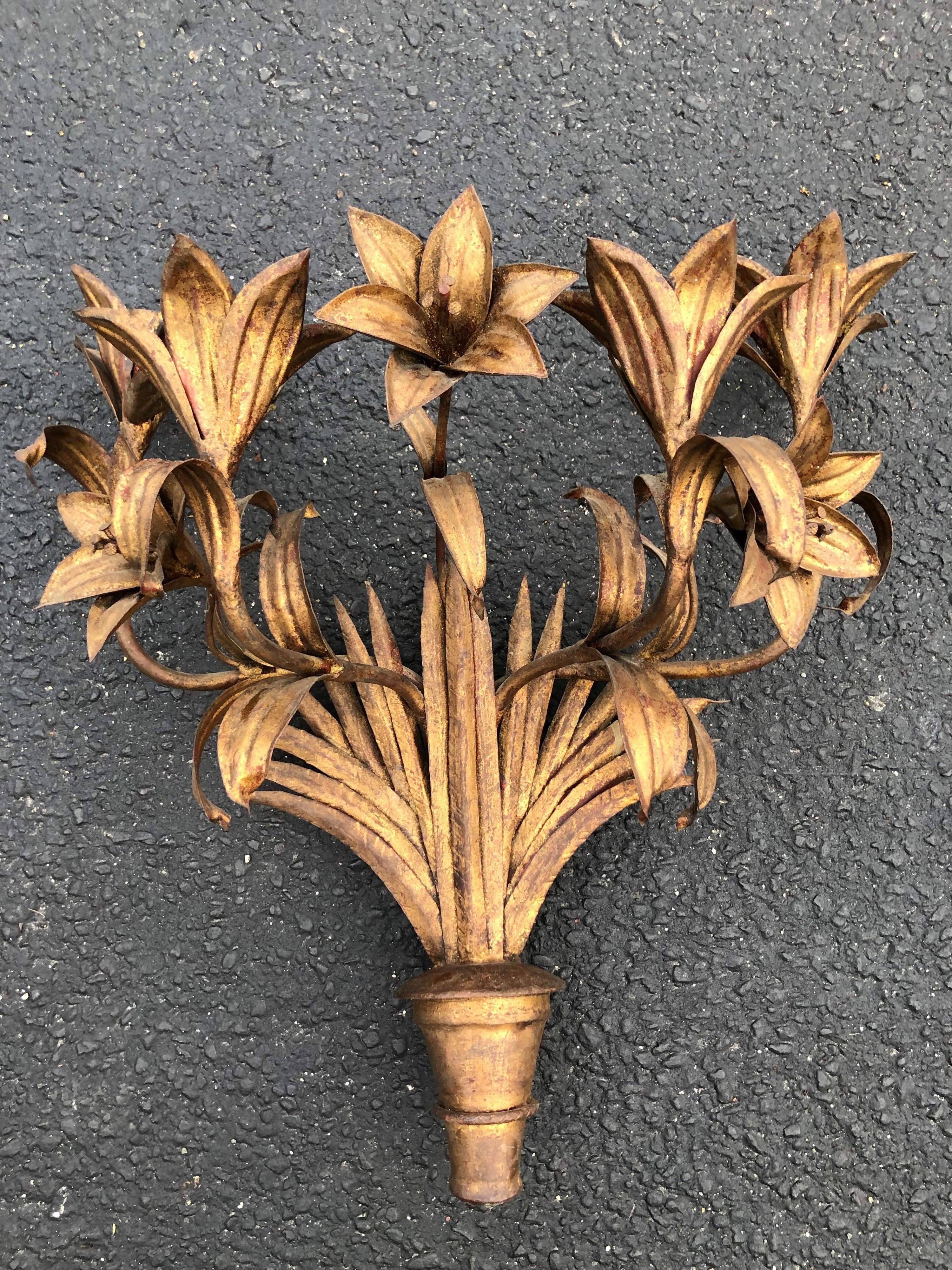 Large Italian gilt iron floral wall sconce. Adorned with five elaborate tiger Lilly flowers. This unique sconce adds texture and depth to any wall. This is not a light fixture but a decorative object. The pointed bouquet bottom is made of wood. This
