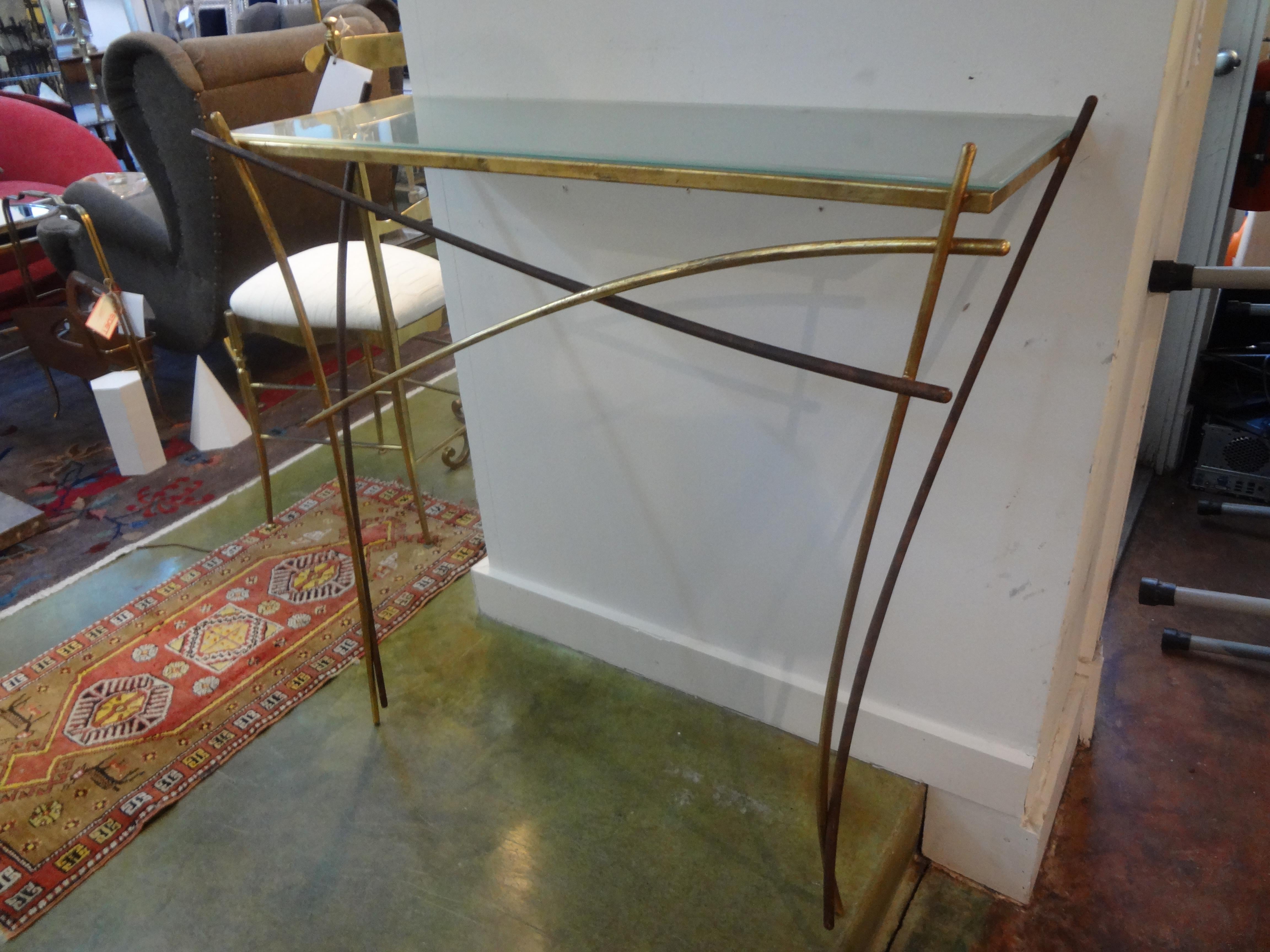 Unusual Italian midcentury Minimalist gilt iron console table with glass top in the style of Gio Ponti. This stunning Postmodern console is wall-mounted and perfect for an area where depth is of concern.