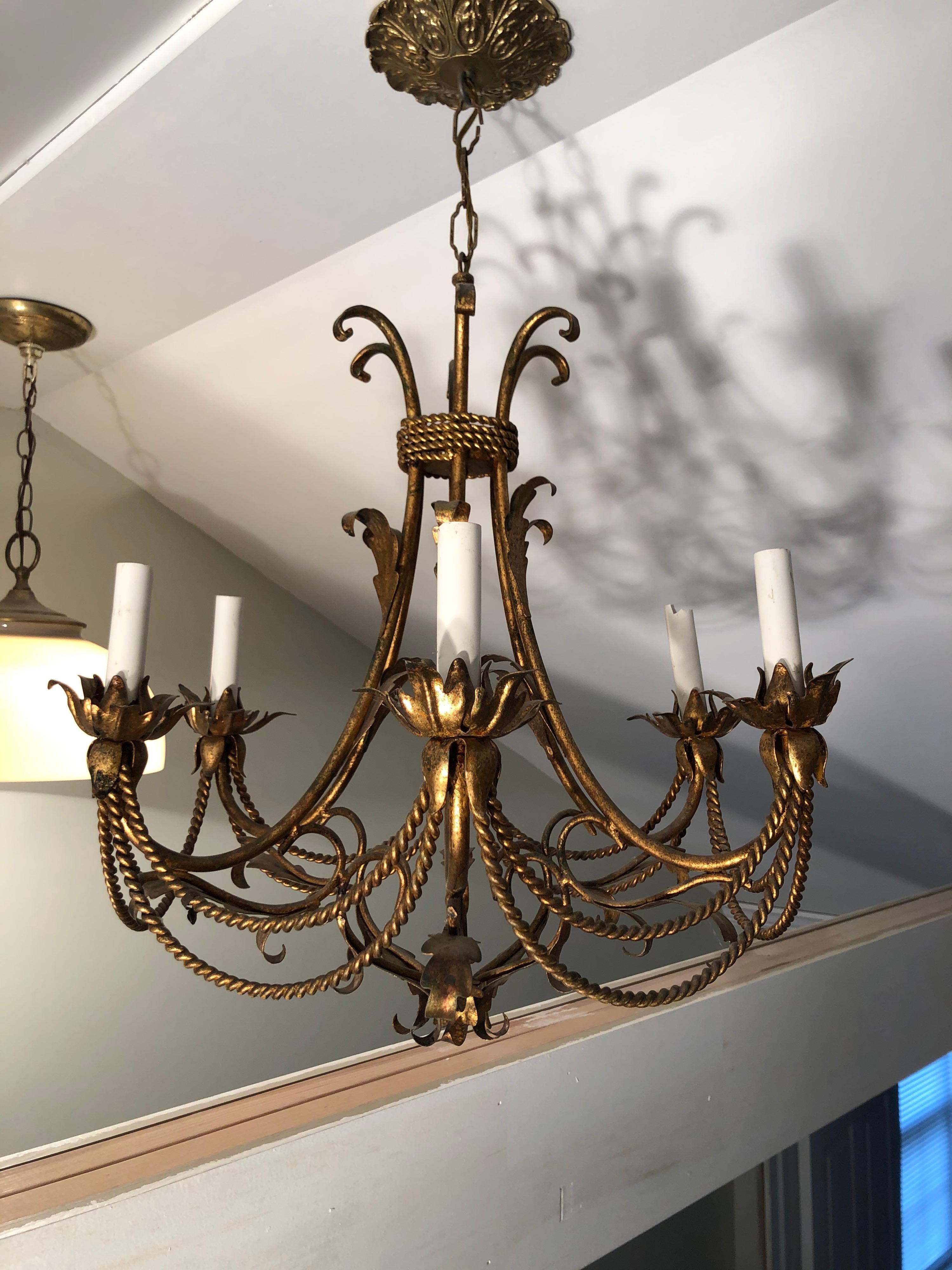 Italian gilt Tole tassel chandelier. This 6-arm chandelier will light up a room with romance. Stunning lines and classic design make this a timeless piece. Matching ceiling plate also included. This item should parcel ship for $45
 