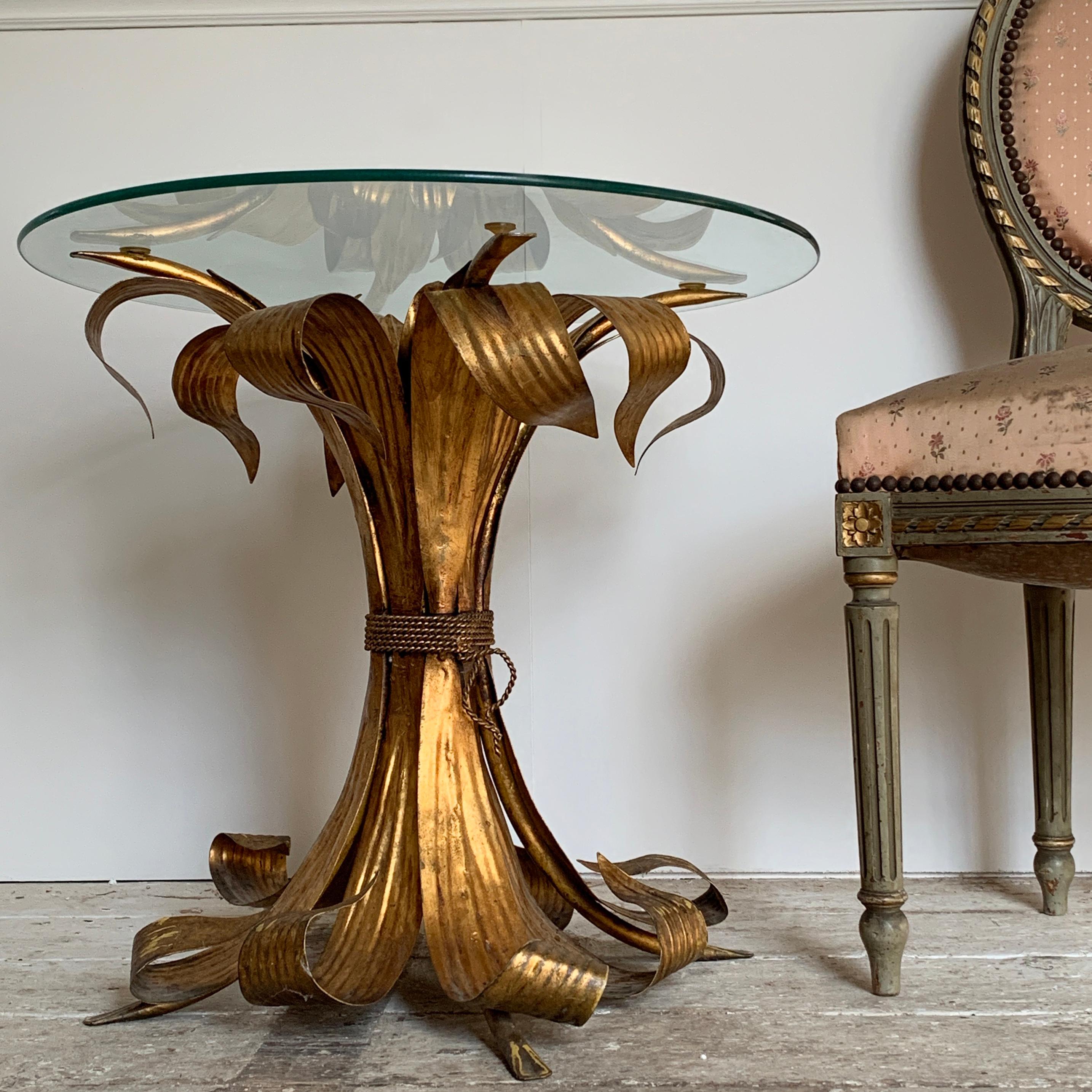 Stunning rare Italian gilt leaf design tole table
The table made from broad sculpted leaves tied at the centre with a metal twisted cord effect detail, the table base is full and thick in size and a real statement piece
circa 1950s-1960s
Beautiful