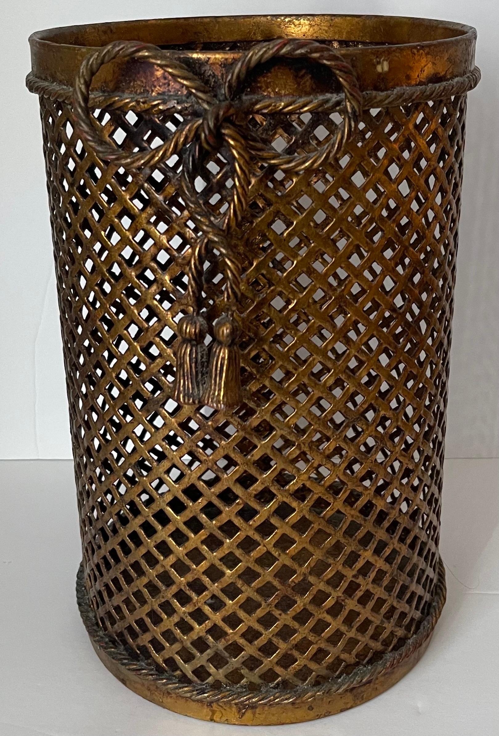 Italian gilt metal wastepaper basket. Rope trim and center rope bow with tassel accent. Signed Made in Italy in the underside.