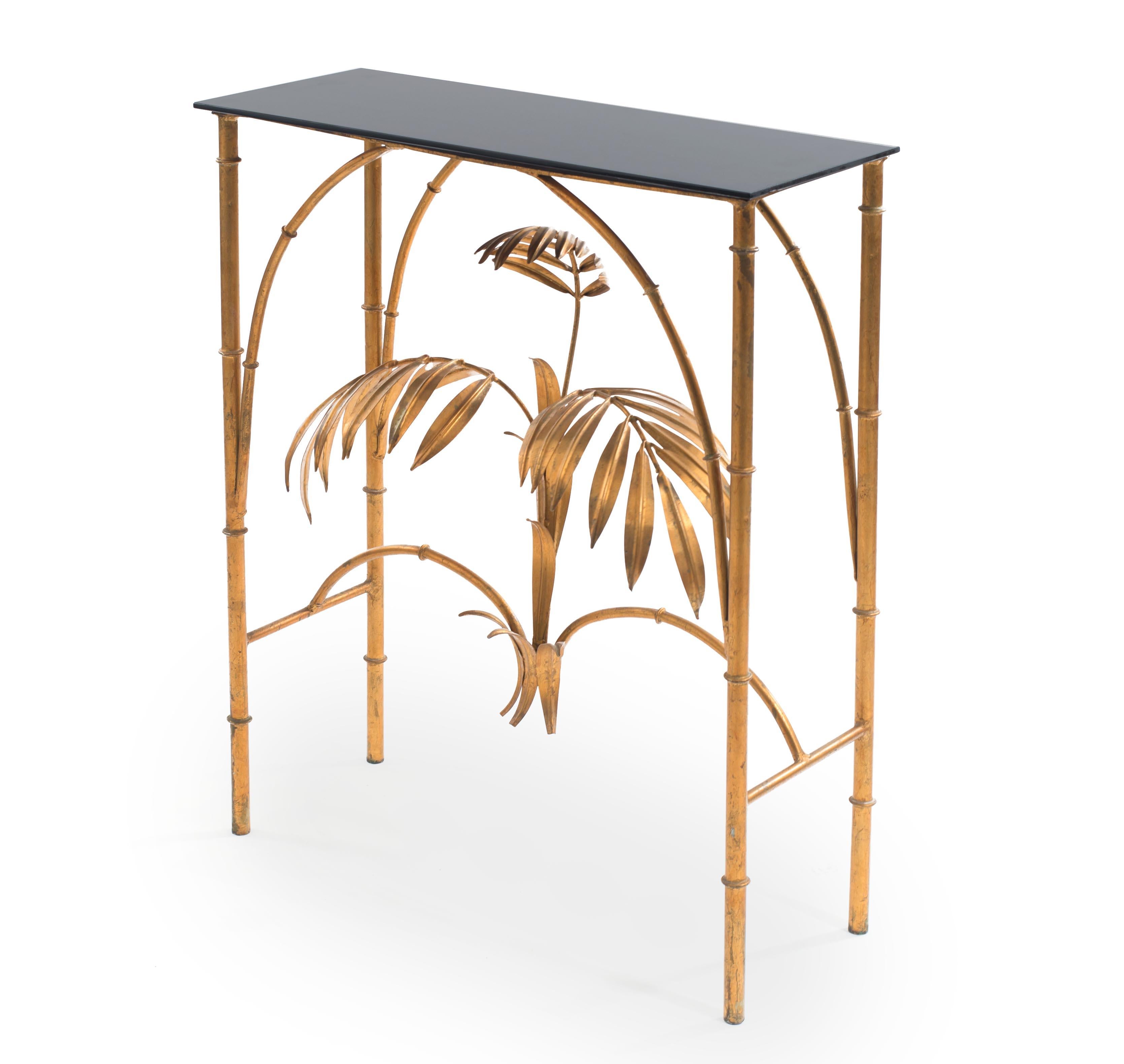 Italian (20th century) faux bamboo gilt metal console table with palm design stretcher and a rectangular black glass top.
 