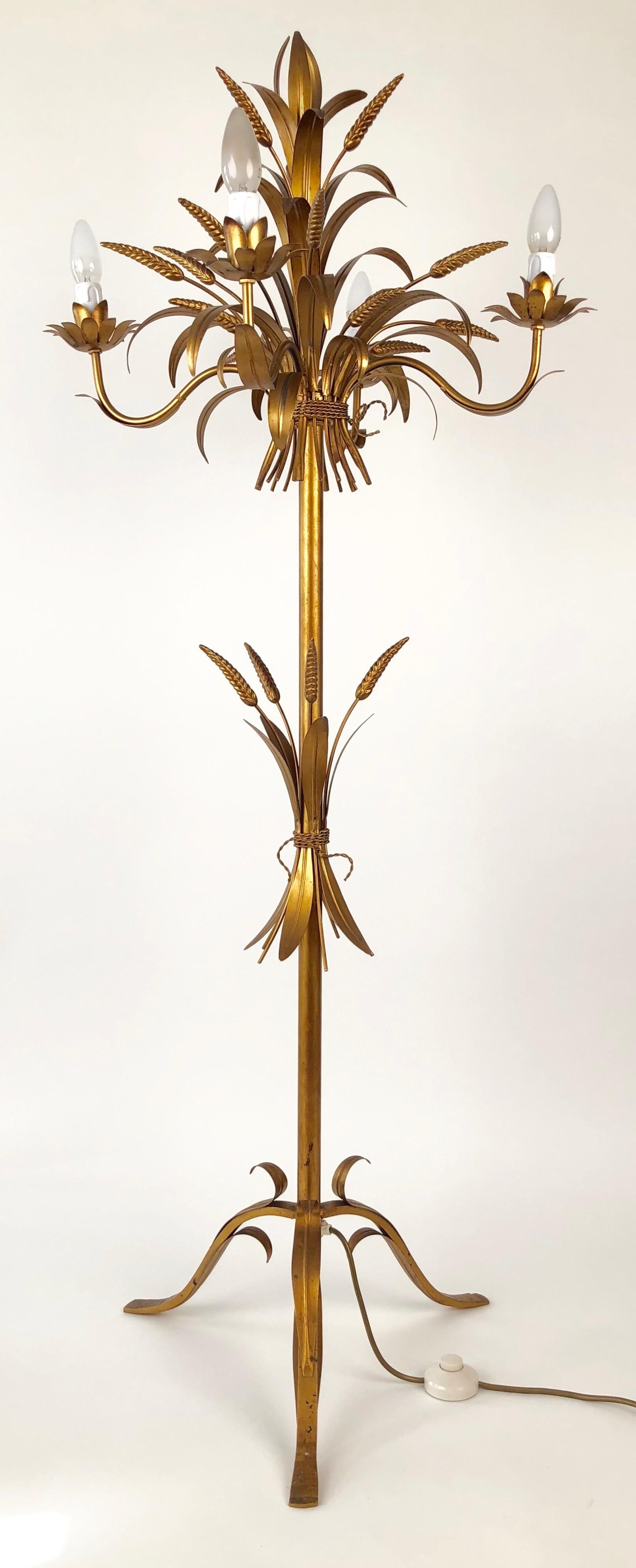 A gilt metal floor lamp from Italy made in the 1960s. This four element candelabra is made up of sheet metal, cast elements and tubing,
that has been hand assembled and coloured. There is sense of Hollywood dramatic in this Regency styled lamp that