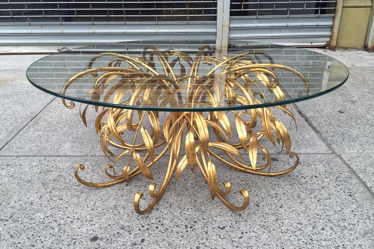 Italian gilt metal floral coffee table with glass top.