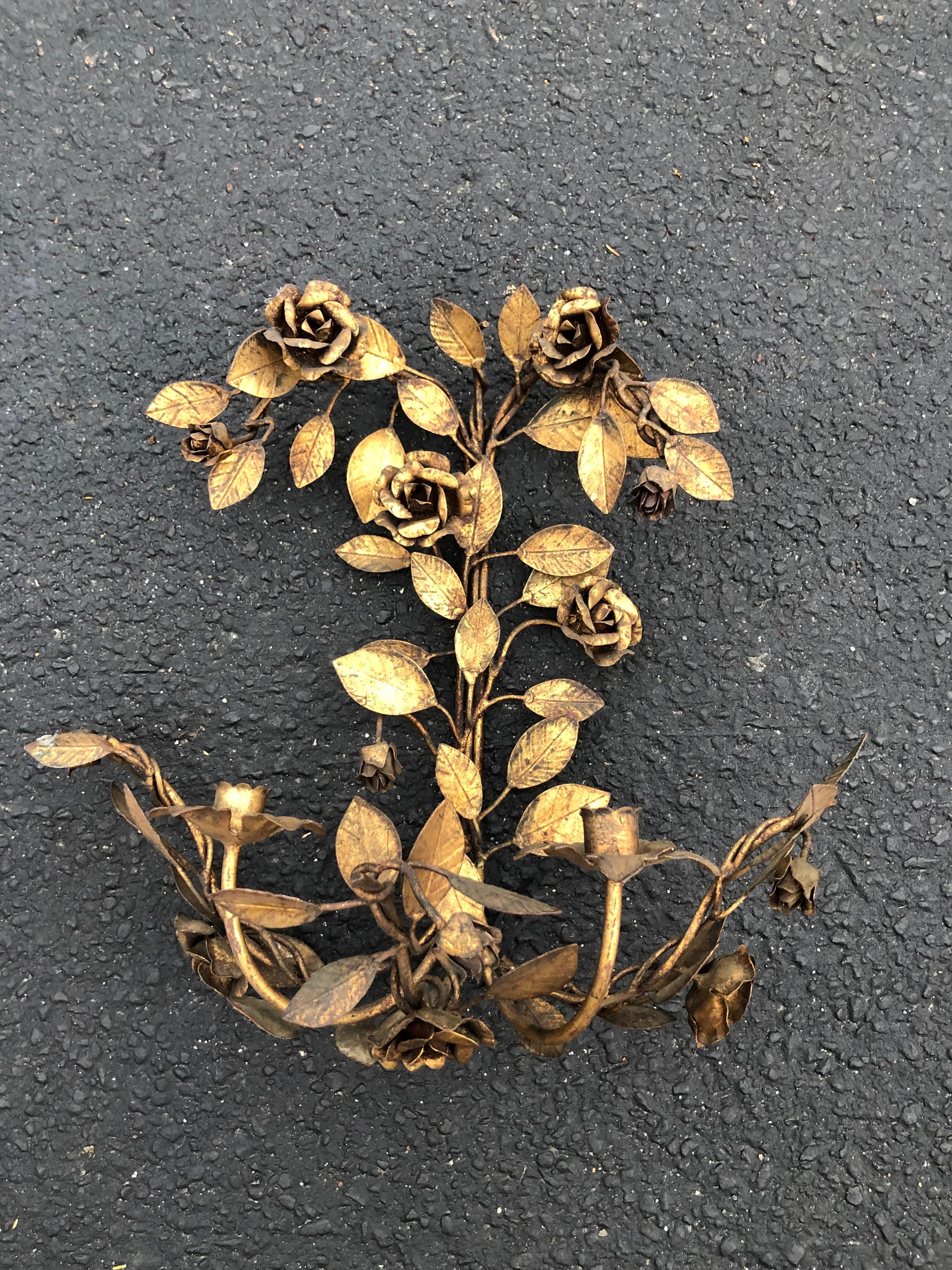 Italian gilt metal floral wall sconce. Elaborate rose and leaf pattern with two candle holders. Romantic Hollywood Regency decor for that dramatic statement. Most likely made in Italy.