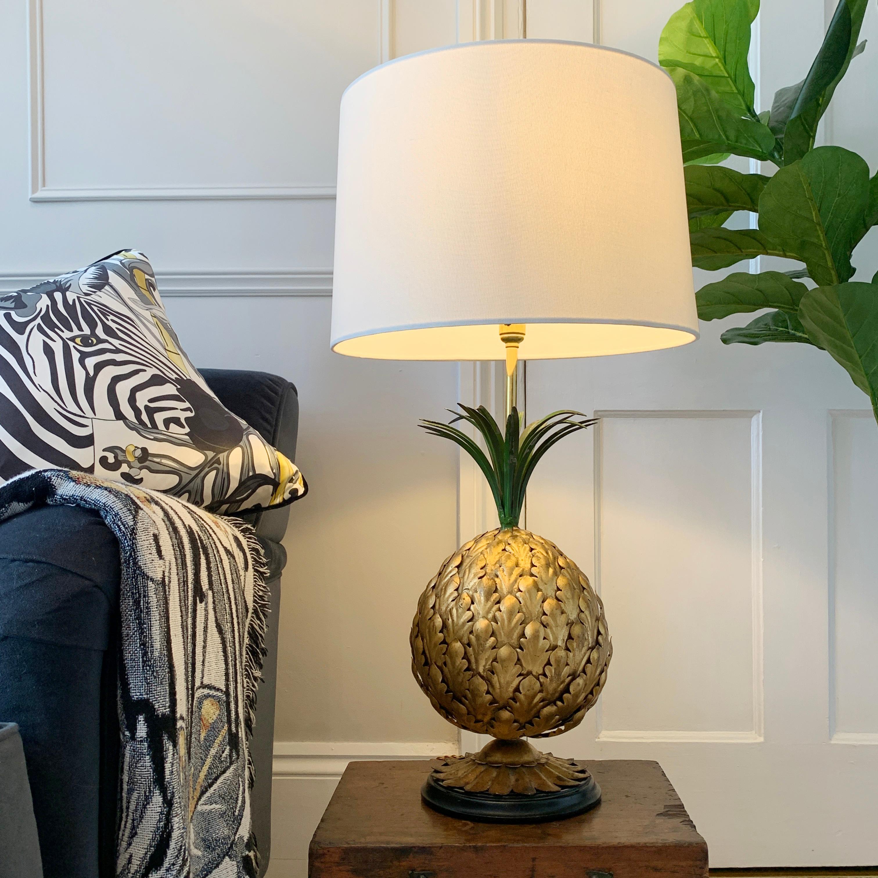 An impressive and beautifully made table lamp in the form of a large Pineapple, the detailed metalwork of the body in gilt with long painted green fronds. This tall and wonderfully elegant lamp is Italian, and made in the 1950’s.

It is of very