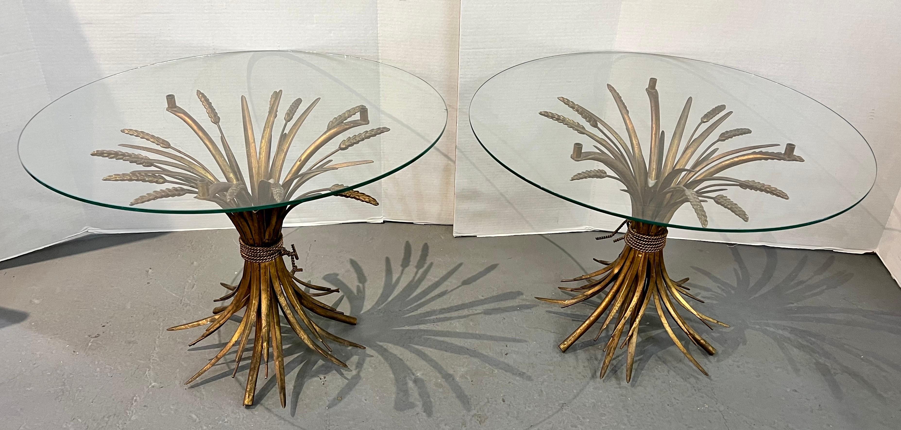 Sculpted from metal in a gold gilt finish, these Sheaf of Wheat side tables includes a sheaf-shaped base and a round clear glass tabletop.