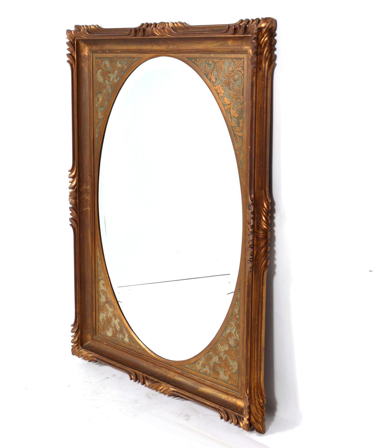 Italian gilt mirror, Italy, circa 1950s. Retains warm original patina to both the giltwood frame and original mirrored glass. It measures an impressive 50