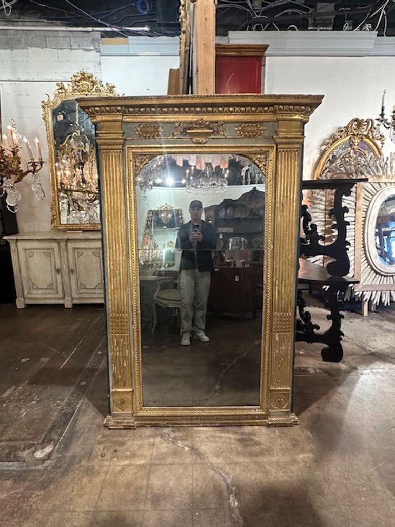 18th century Italian carved and parcel gilt mirror from Rome. Circa 1780. Sure to make a statement!