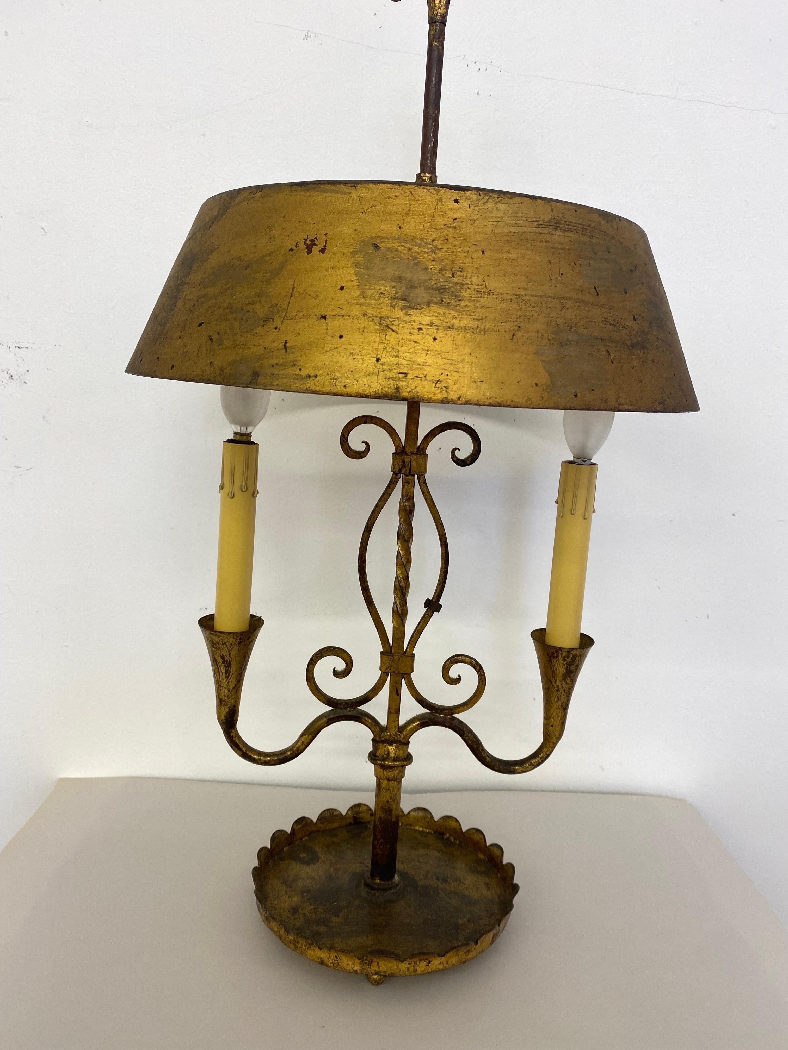 Gilt metal tble lamp with an adjustable shade. Nicely made with Italy tag still attached. Gilt shows nice patina and wear.