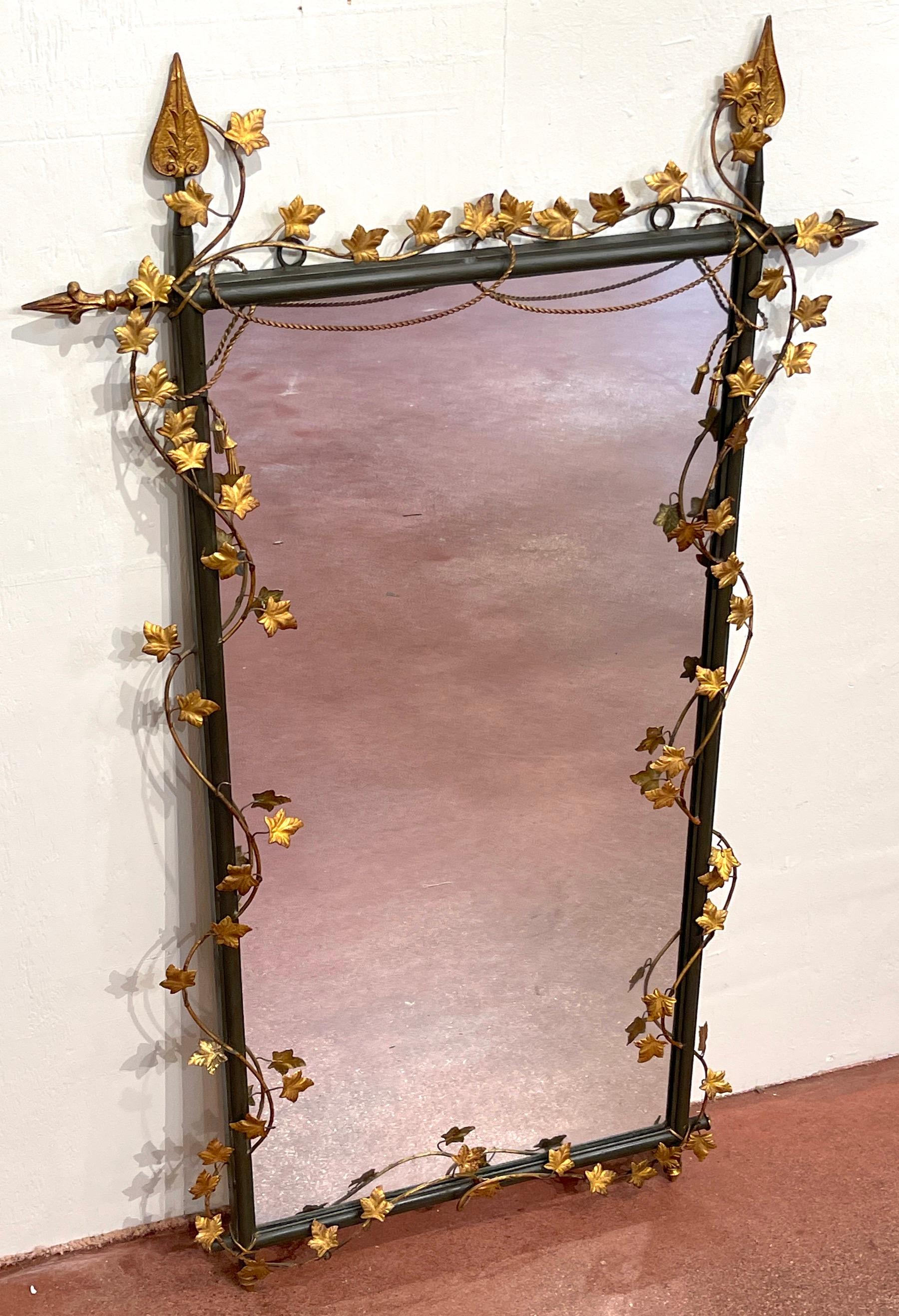 Italian Gilt & Polychromed Neoclassical Tole Trellis & Vine Motif Mirror 
Of fine proportions, the verdigris arrow columns/ trellis with continuous intertwined gilt tole vines and leaves, presenting a 44-Inch high x 21-Inch wide mirror. 
Overall