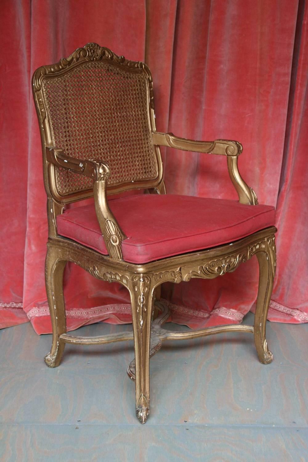 An exquisite Italian gilt Rococo style armchair. This beautiful armchair is crafted from the finest materials and designed with intricate attention to detail. Its stylish gold-painted frame perfectly accents the intricate details and decorative