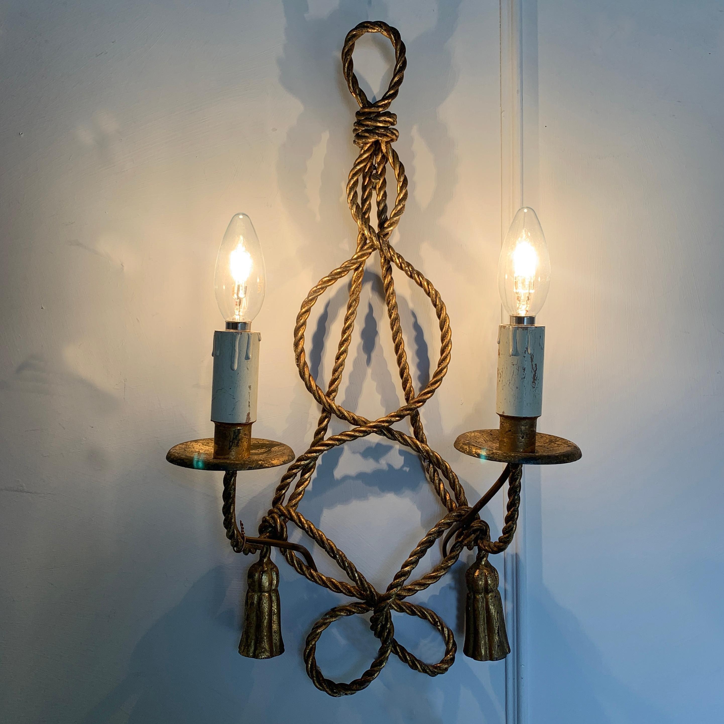 Italian gilt rope and tassel wall lights, circa 1950s
These large wall lights are crafted in solid gilt rope effect metal
Measures: 51 cm height, 26 cm width, 13.5 cm depth
There are 3 lampholders per light, each taking E14 small screw in