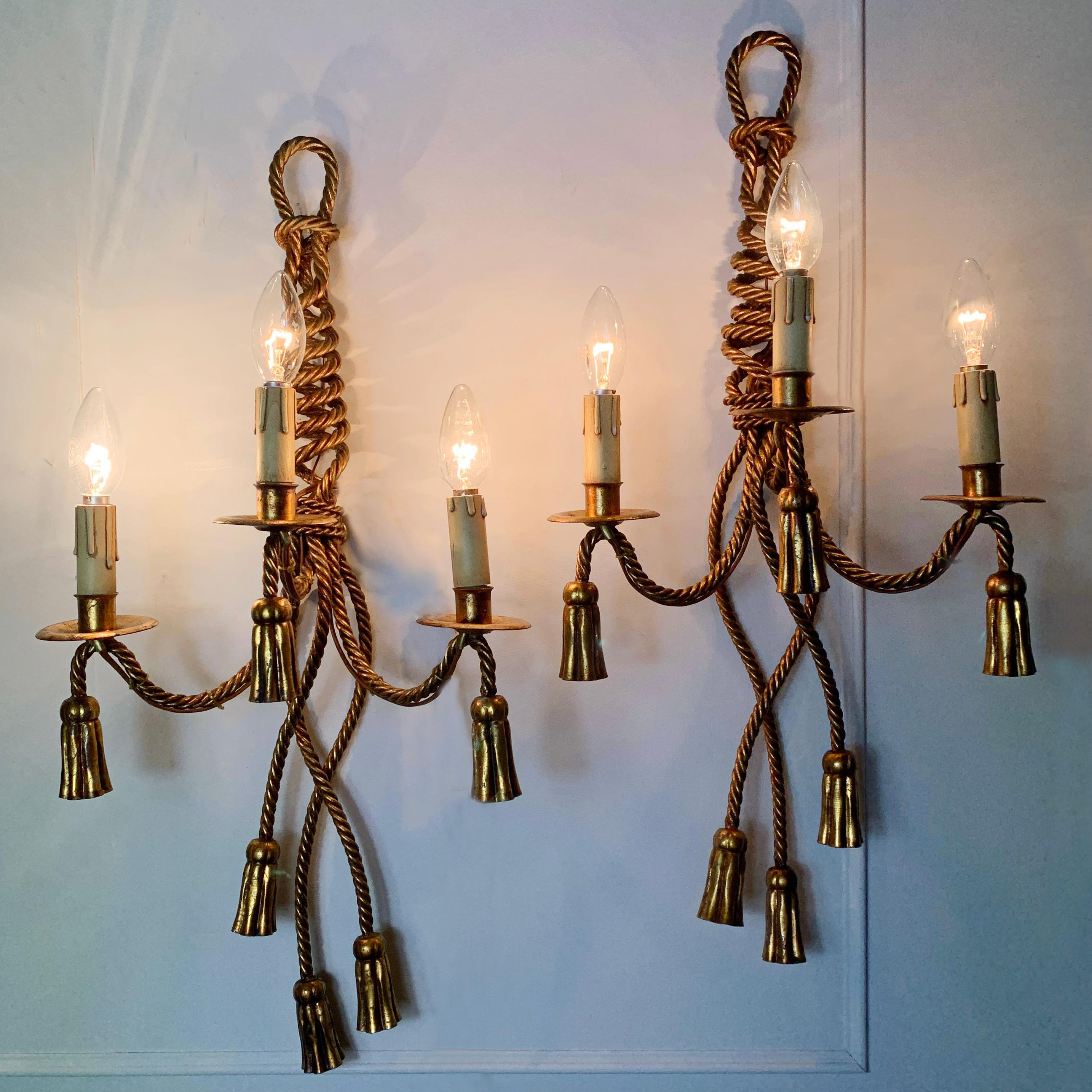 Italian gilt rope and tassel wall lights, circa 1950s
These large wall lights are beautifully crafted in solid gilt rope effect metal
They are heavy, large, high quality lights
Measures: 70 cm height, 33 cm width, 18.5 cm depth
Pat tested
There