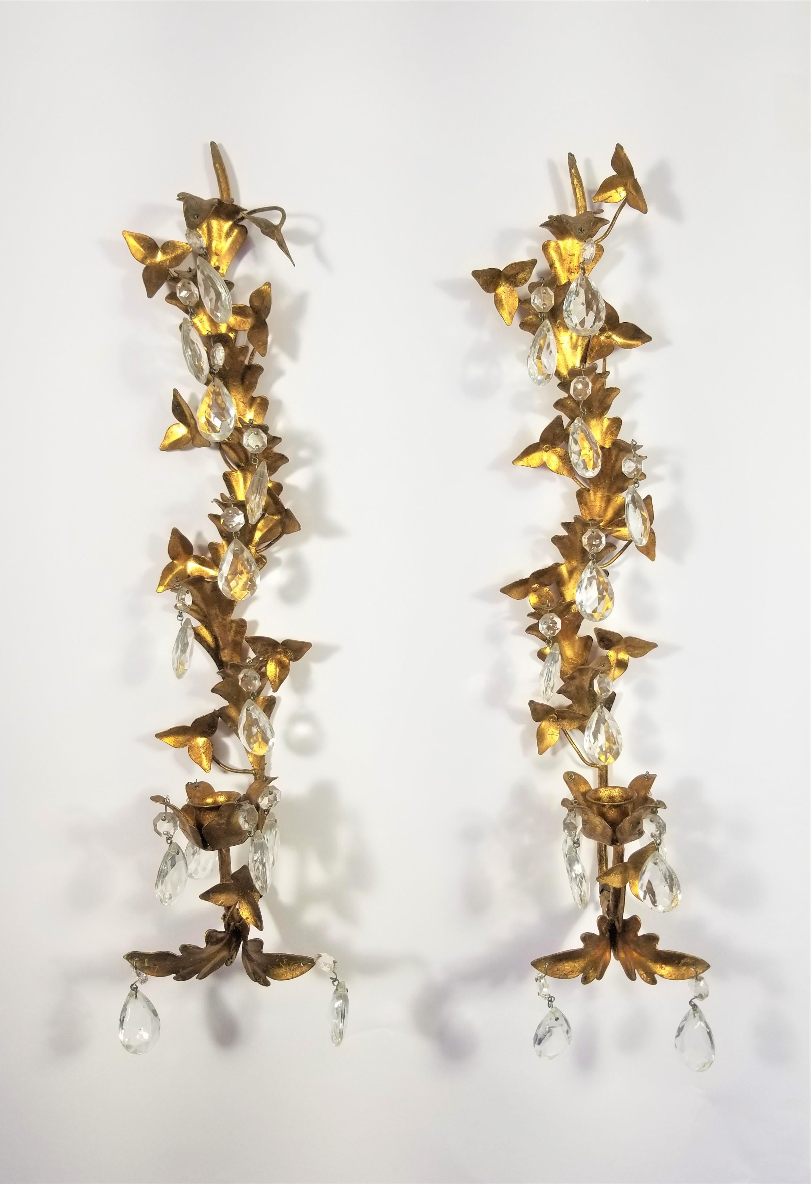 Pair of Mid Century 1950s Gilded Sconces with crystals.. One candleholder on each. Both retain metal marking tag made in Italy. 