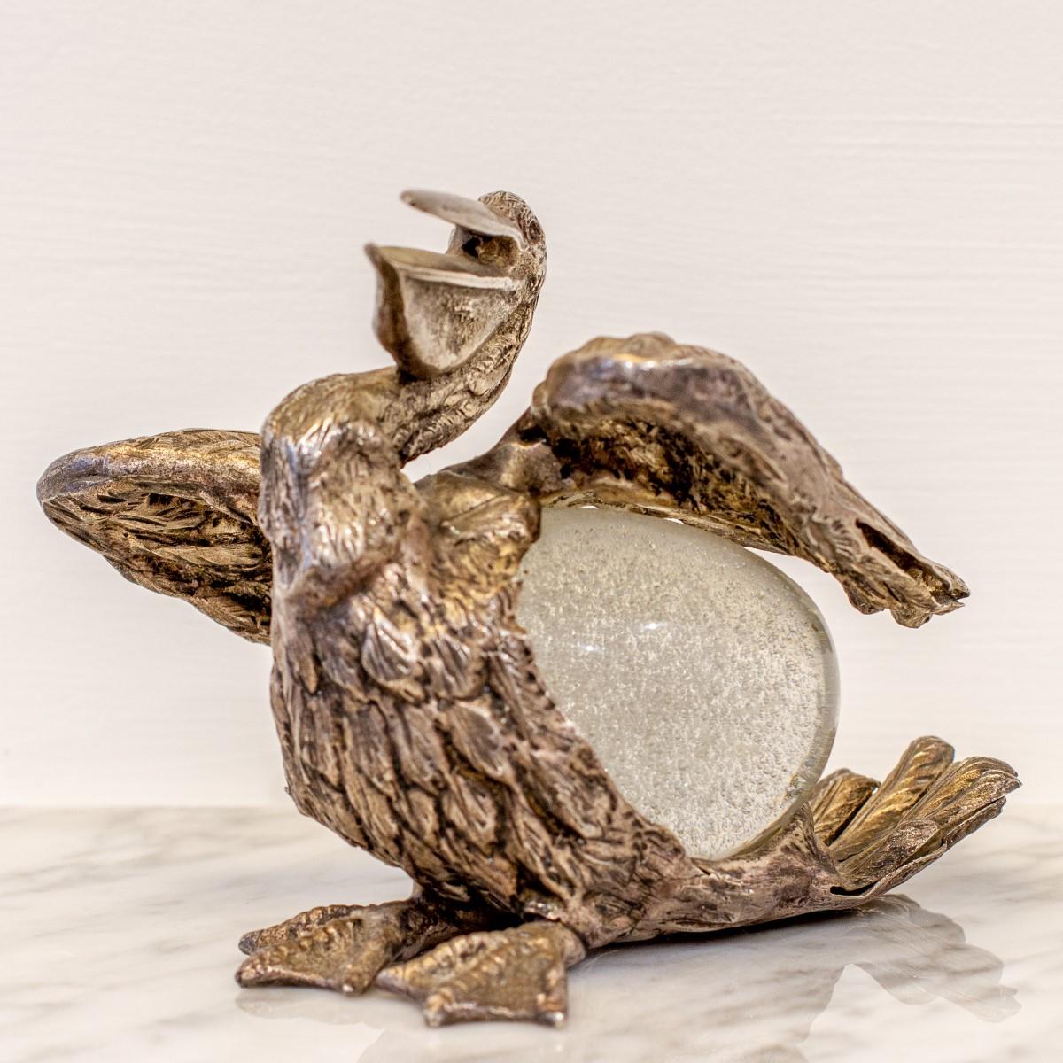 An Italian gilt silver bronze pelican by Gabriella Crespi with a hand-blown glass egg body and signed to the underside, circa 1970-1974. 

Gabriella Crespi (1922-2017) was an Italian artist who transformed objects by changing their function so