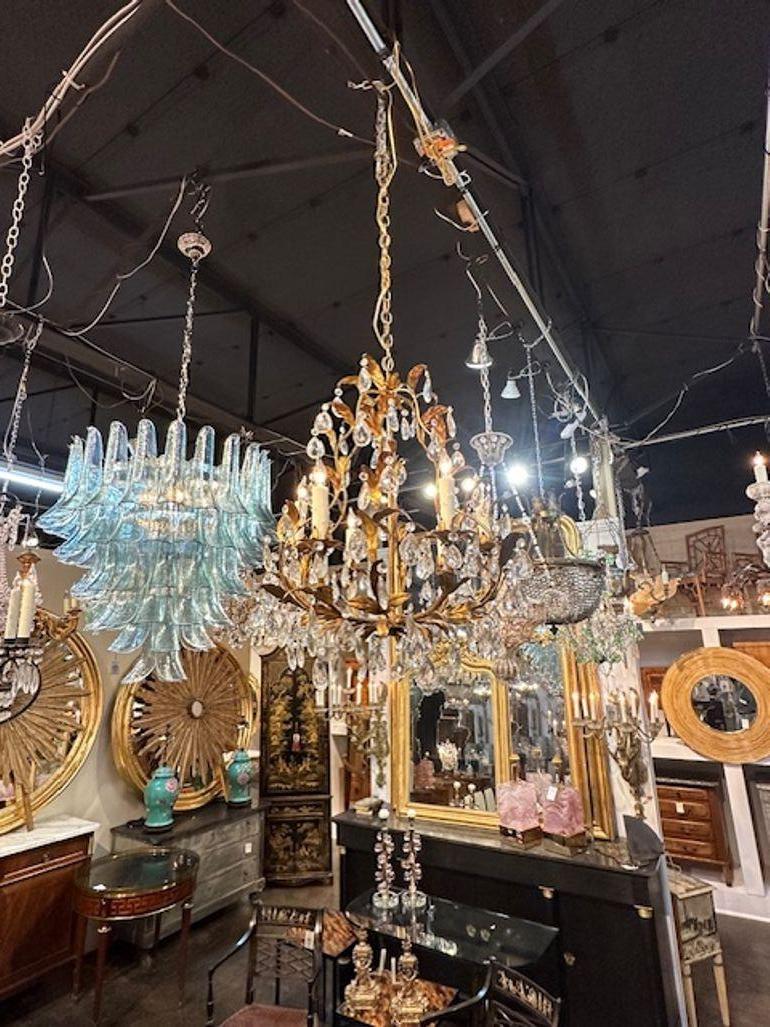 Early 20th century Italian gilt tole and crystal chandelier. Circa 1920. The chandelier has been professionally rewired, comes with matching chain and canopy. It is ready to hang!