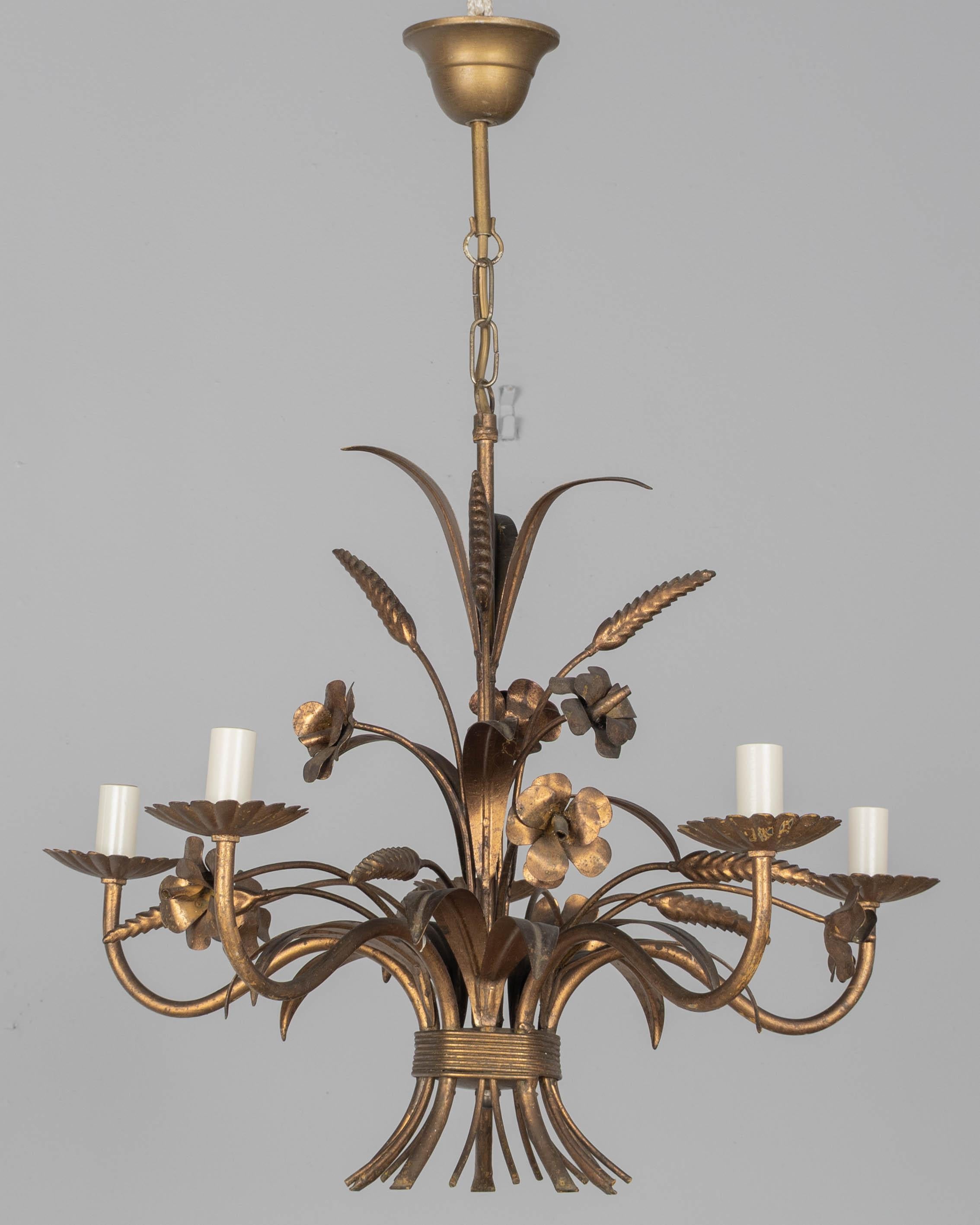A Hollywood Regency style five-light gilt metal chandelier with flowers and sheaf of wheat. Designed by Hans Kögl and made in Italy. New sockets and candle covers. In working order. Good original vintage condition with minor wear consistent with age