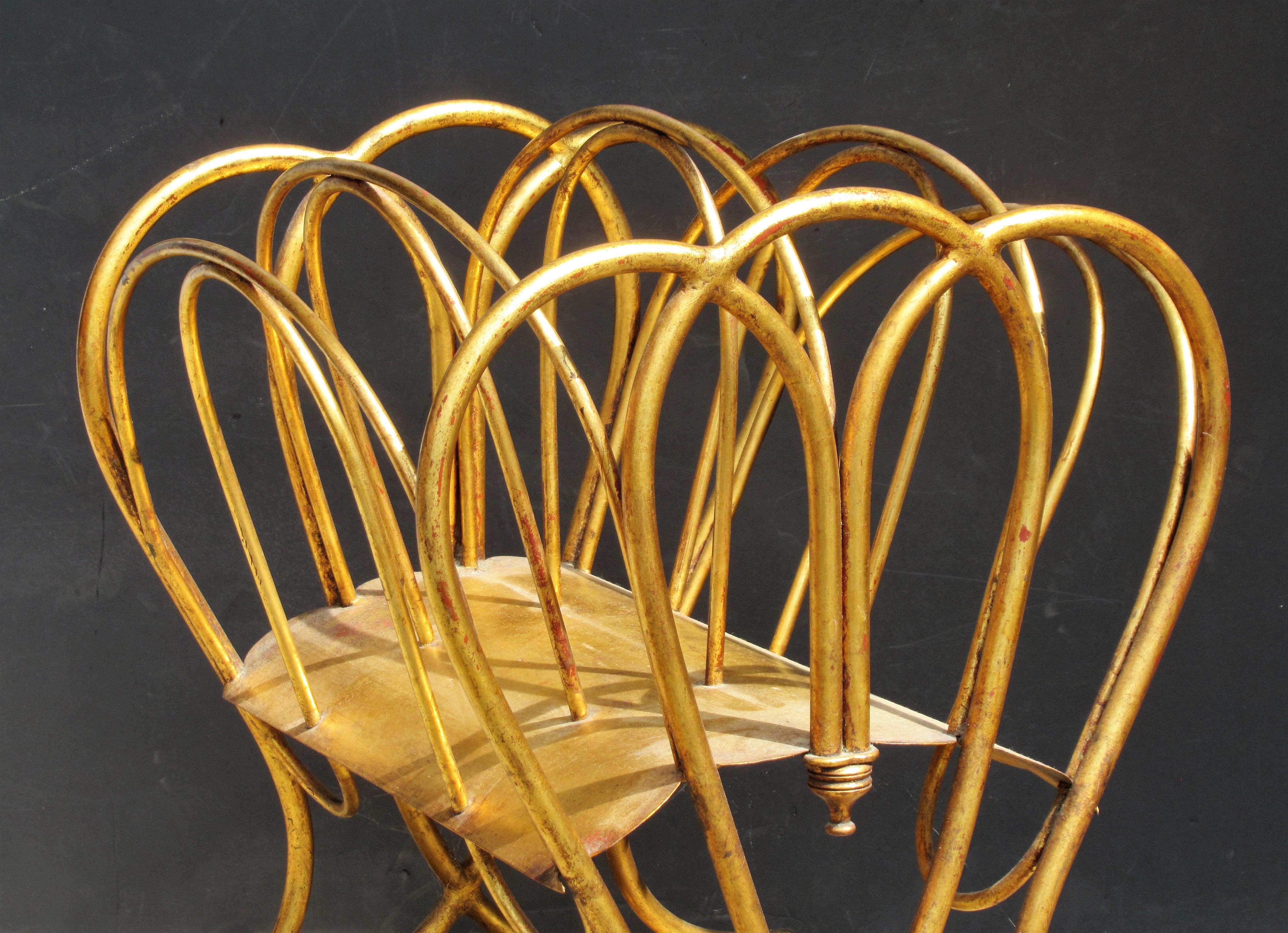 Italian gilt tole metal magazine rack stand with beautifully aged original gilded surface showing some areas of underlying red bole, circa 1960's. Great quality. This one is a beauty.  Look at all pictures and read condition report in comment