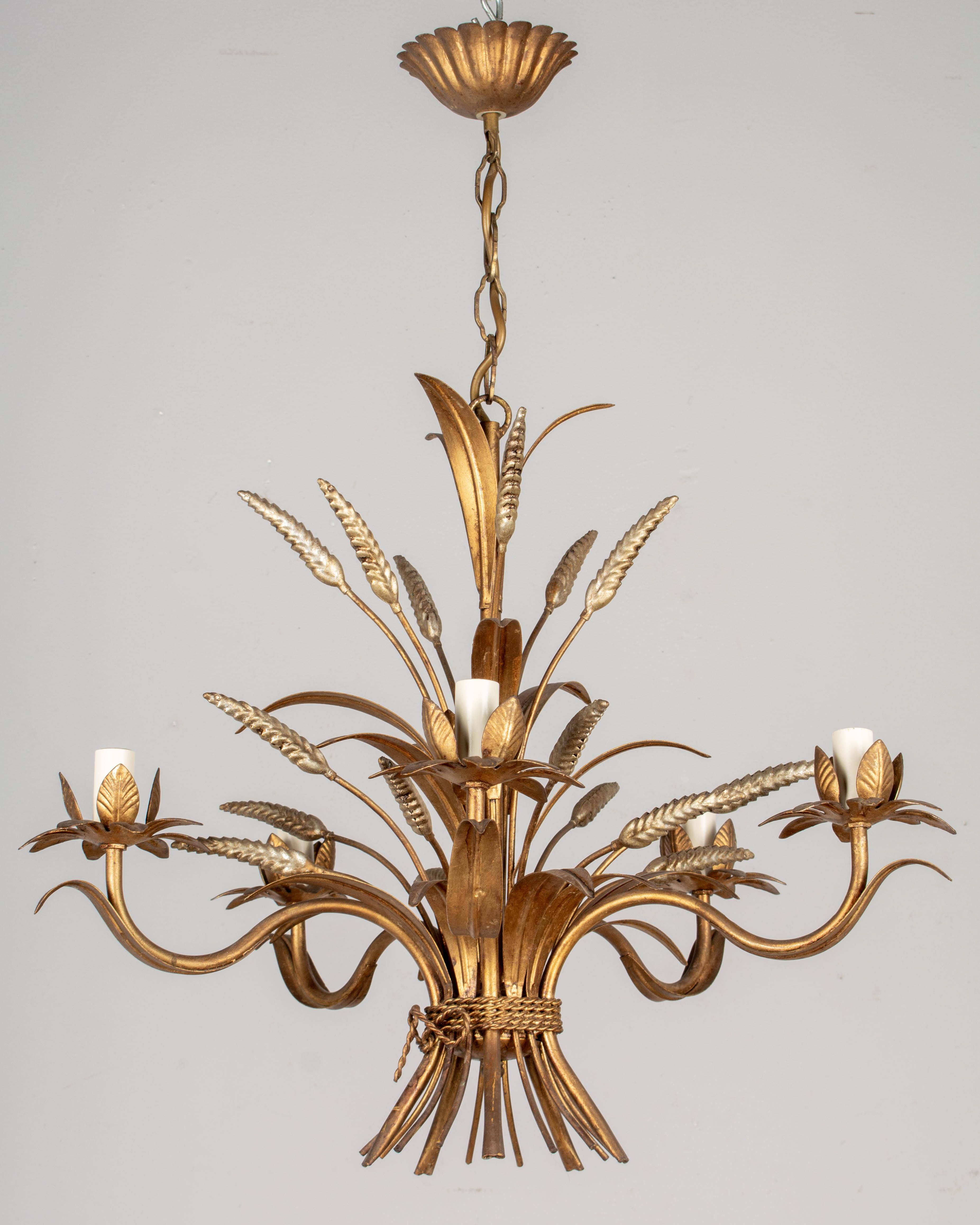 A Hollywood Regency style five-light gilt metal chandelier with silver sheaf of wheat. Designed by Hans Kögl and made in Italy. New sockets and candle covers. In working order. Good original vintage condition with minor wear consistent with age and