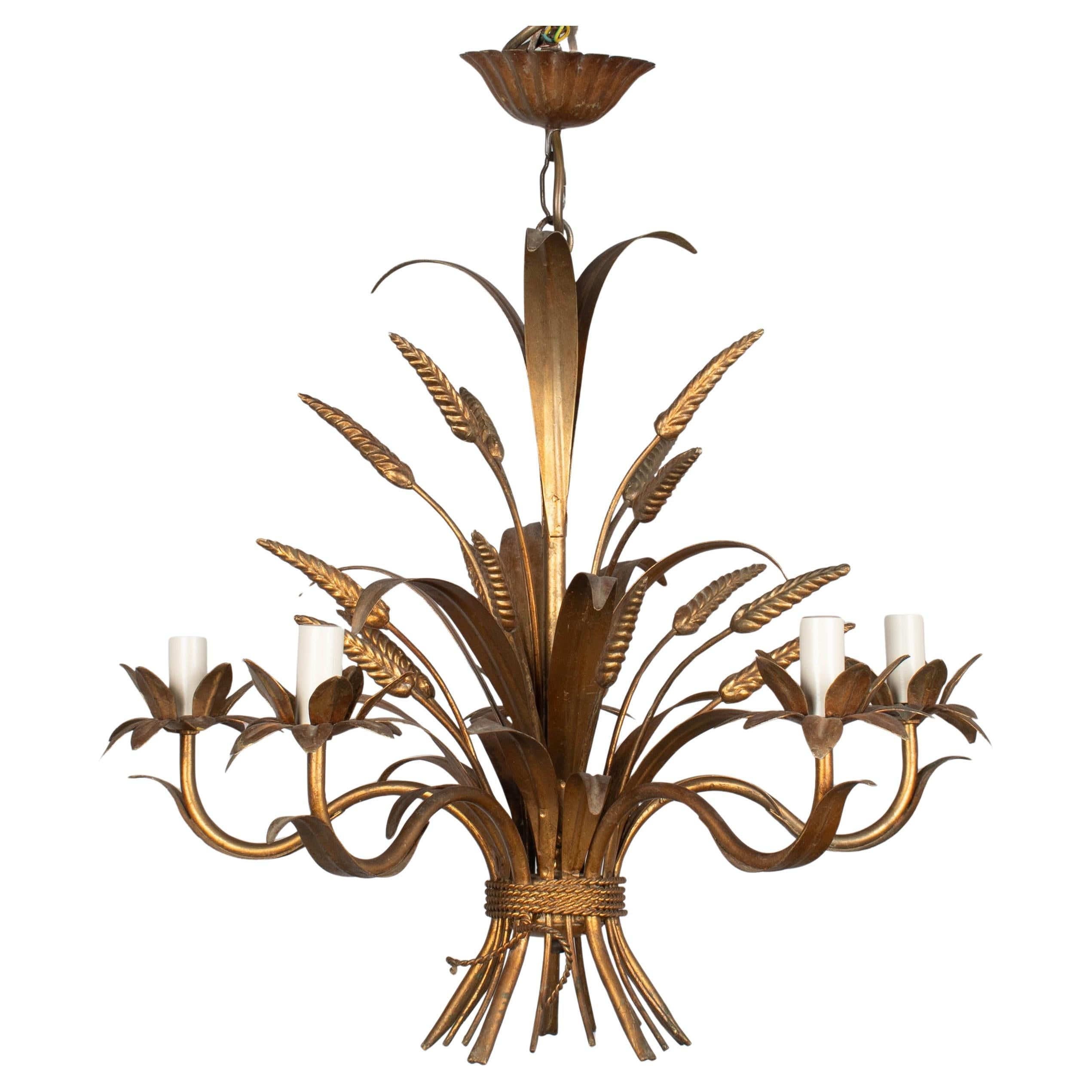 A Hollywood Regency style five-light gilt metal chandelier with sheaf of wheat. Designed by Hans Kögl and made in Italy. New sockets and candle covers. In working order. Good original vintage condition with bright gilt finish. Circa