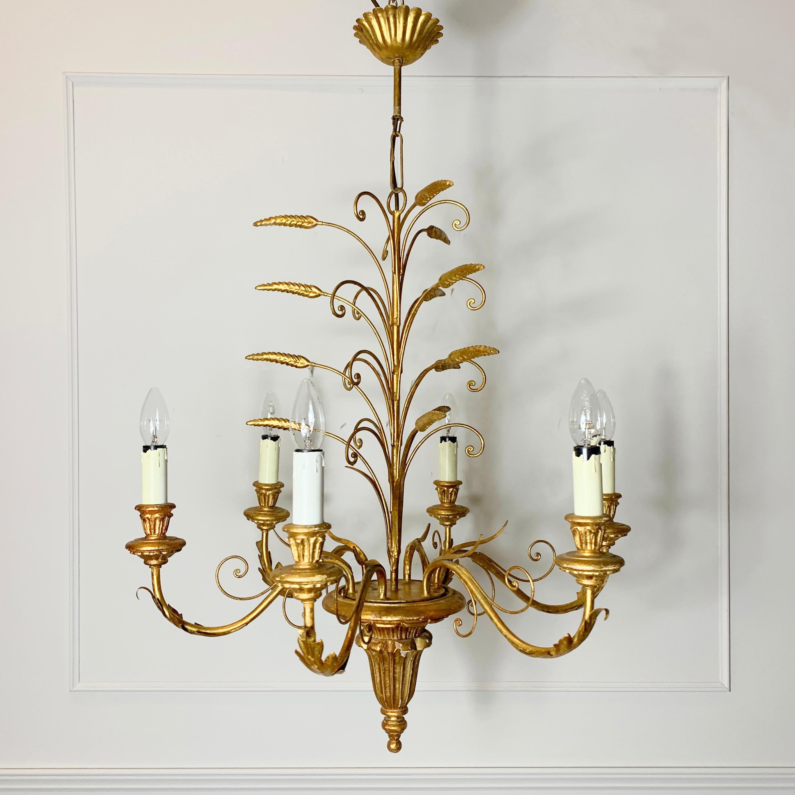 1960s Italian gilt wheatsheaf chandelier
Stunning large size wheatsheaf chandelier in gilt metal and hand carved wood
This 6 bulb chandelier is in its original gold leaf gilt finish

Measures: 
92cm total height, 66cm width, rose 12cm