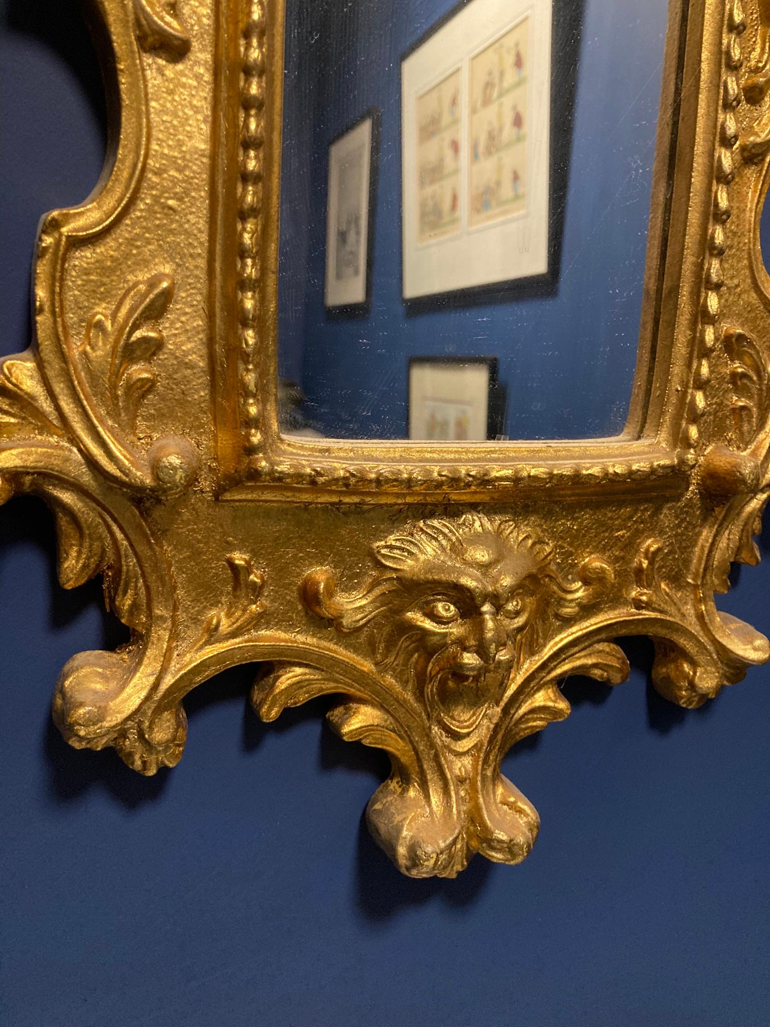 Specchio italiano in legno dorato in stile barocco. Questo squisito specchio con cornice dorata è un'aggiunta straordinaria a qualsiasi arredamento, grazie a un design elegante che ne esalta il fascino lussuoso. Lo specchio è coronato da una statua