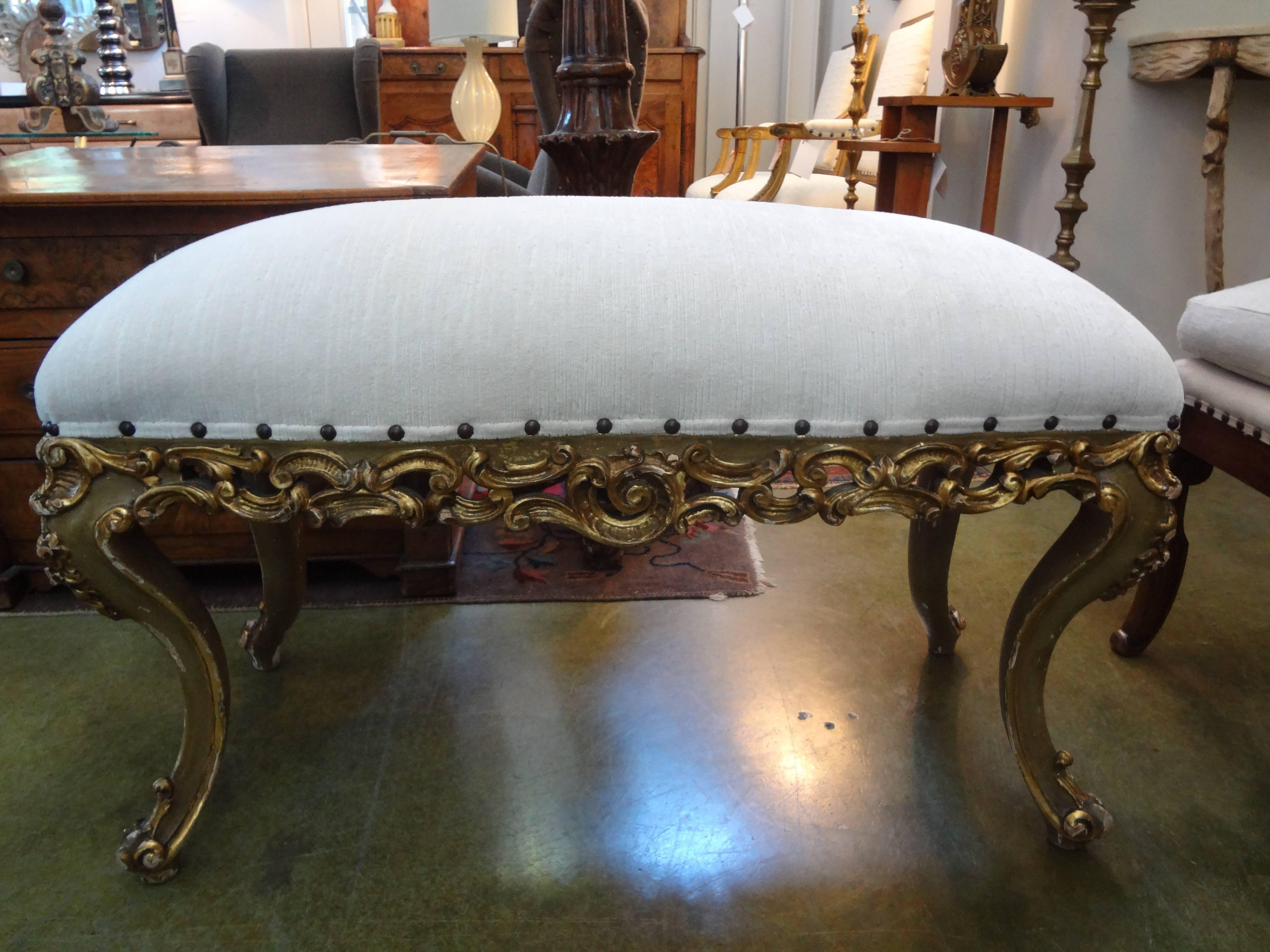 Italian giltwood bench with exaggerated legs.
Stunning Italian gilt wood bench with exaggerated legs. This 1920s Italian bench was taken down to the frame and professionally upholstered in striated velvet with spaced brass nail head detail. This