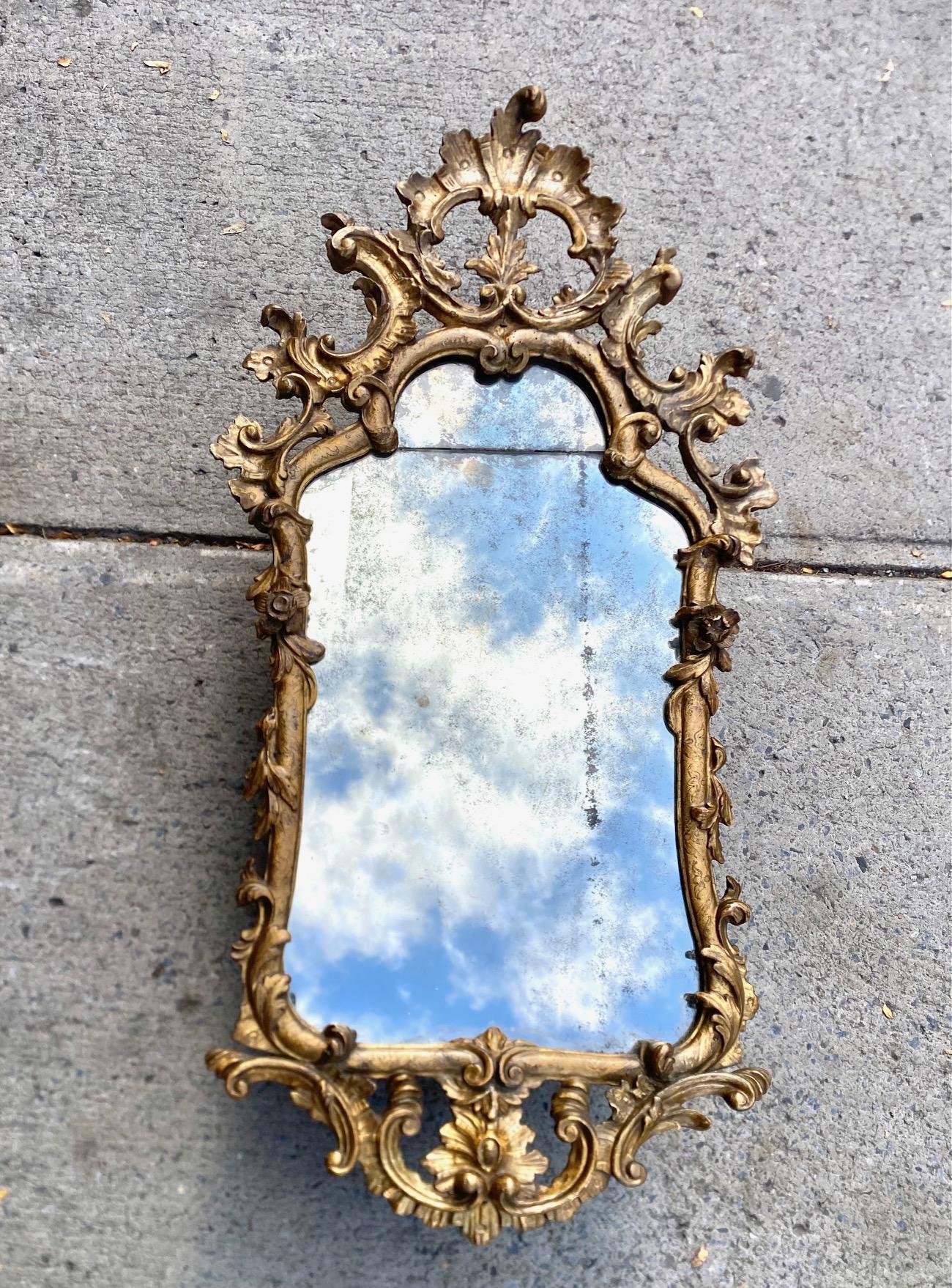 Specchio rococò italiano in legno intagliato e dorato.