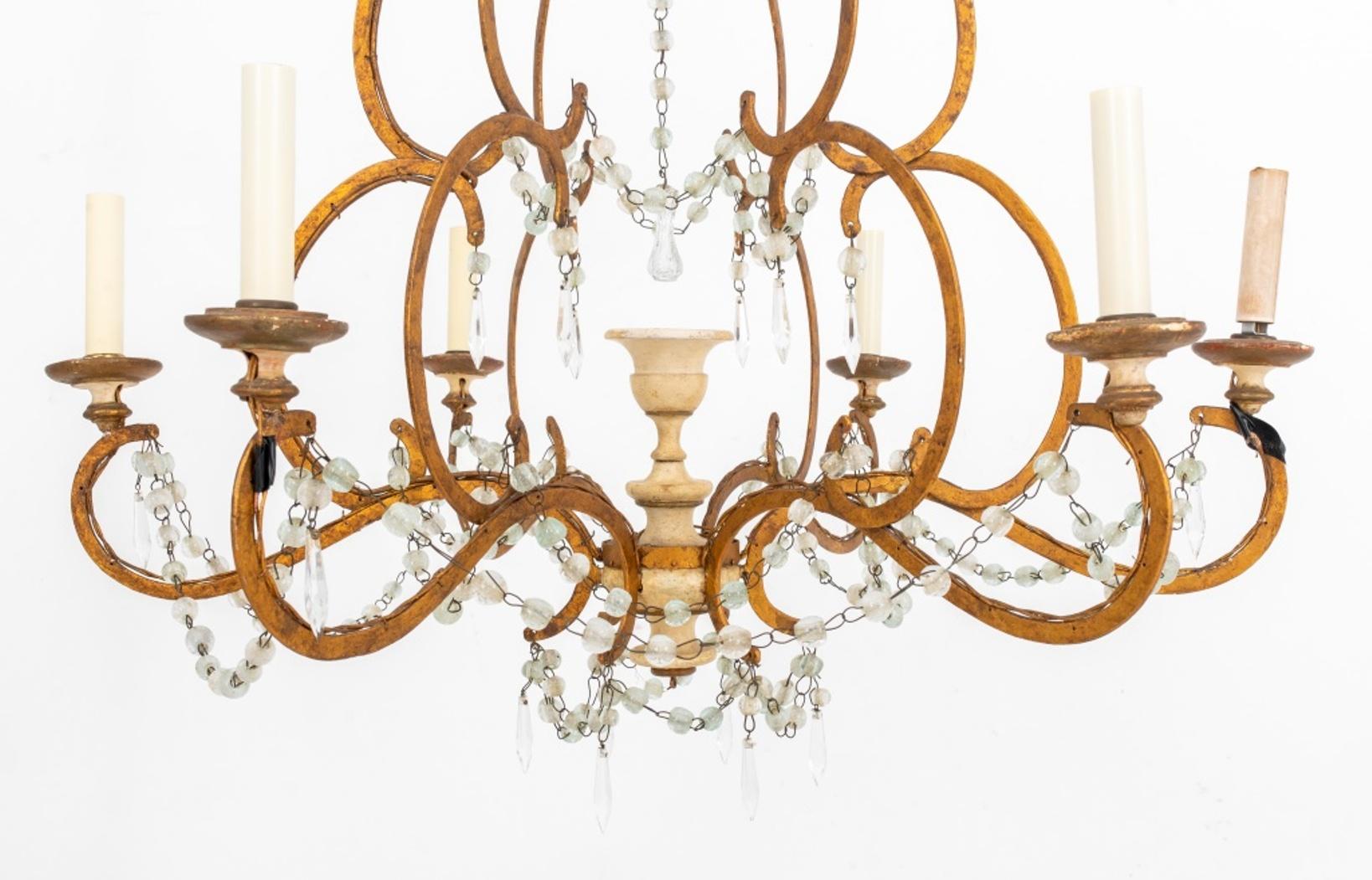 Italian painted wood and giltmetal cage form crystal hung six light chandelier, with turned canopy conjoining six s-curve supports around a painted wooden urn, each mounted with a single c-scroll candle arms, the whole hung with