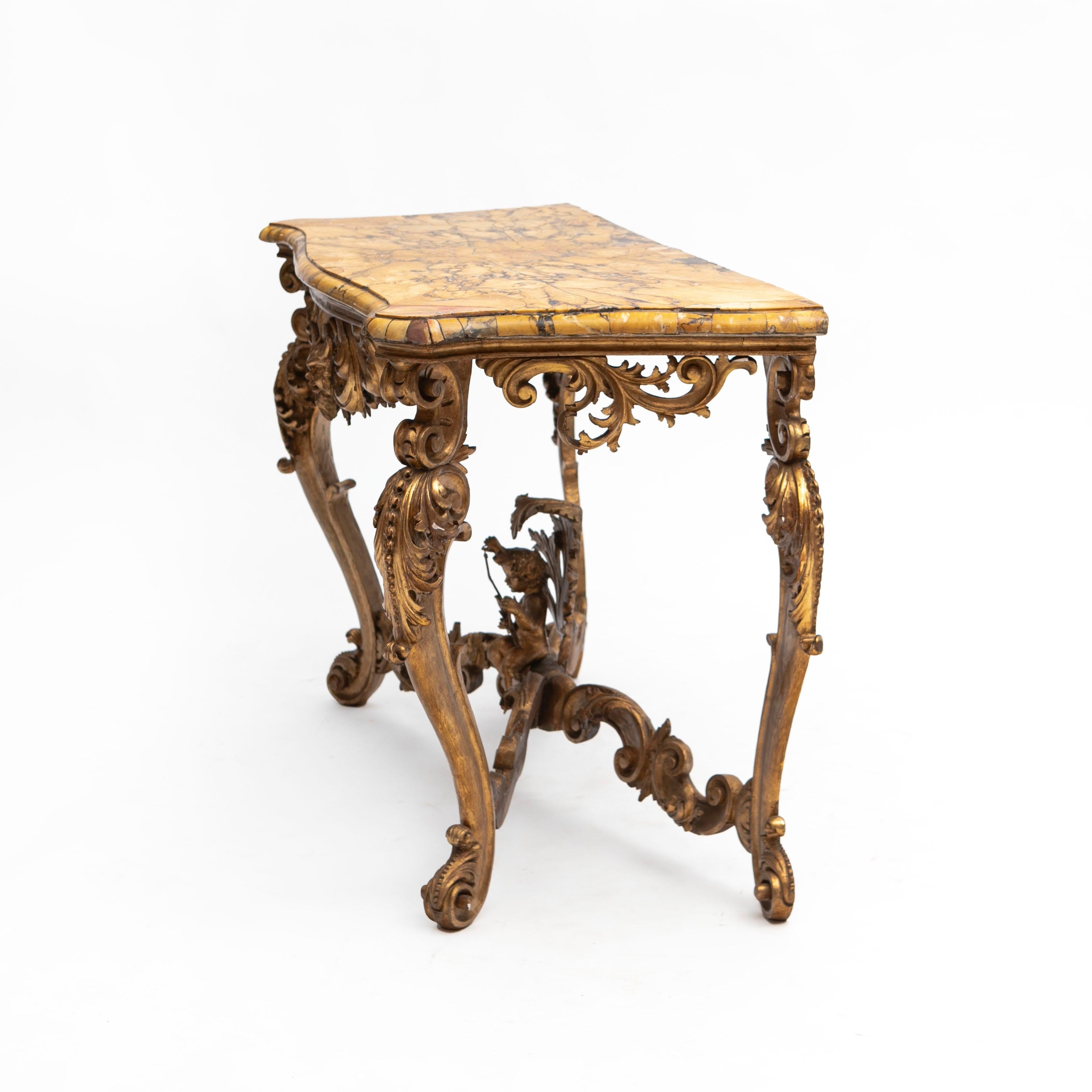 Italian 19th Century giltwood and Breche D’Alep marble console table.
Richly hand-carved gilt wood in the form of masquerades, acanthus leafs, etc.
Stunning Breche D'Alep marble top, inlaid in fragments, giveing the table top an stunning and