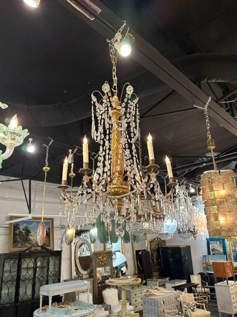 18th century Italian giltwood and crystal chandelier from Genoa. Circa 1780. The chandelier has been professionally rewired, comes with matching chain and canopy. It is ready to hang!