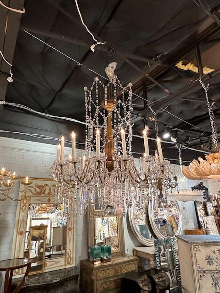 Large and impressive 19th century Italian giltwood and crystal chandelier from Genoa. Circa 1880. The chandelier has been professionally rewired, comes with matching chain and canopy. It is ready to hang!