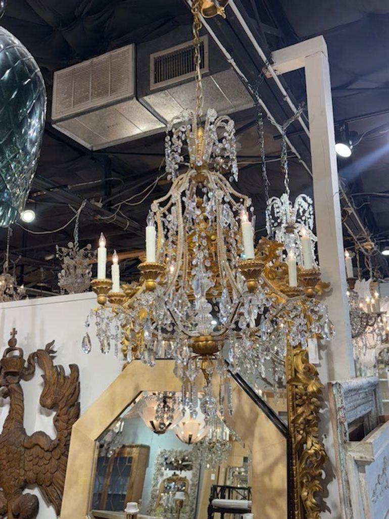 Early 20th century Italian giltwood and crystal pagoda form chandelier from Genoa. Circa 1940. The chandelier has been professionally rewired, comes with matching chain and canopy. It is ready to hang! 40h x 32w