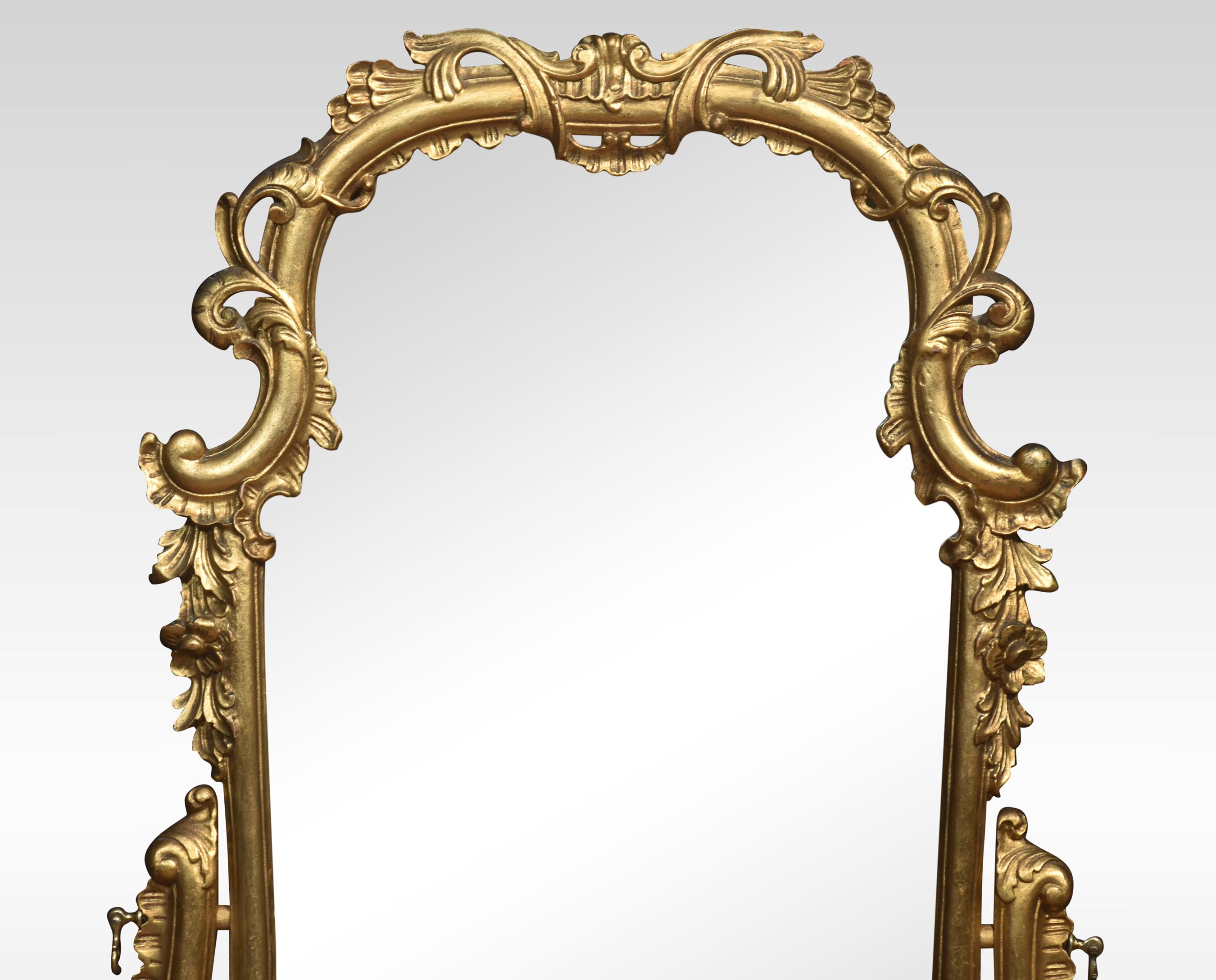 Italian giltwood and figured walnut dressing mirror of Rococo style, the long scrolled foliate frame mounted on scrolled supports, over a pair of bombé petite commodes with well-figured tops and a cupboard door below all raised on splayed