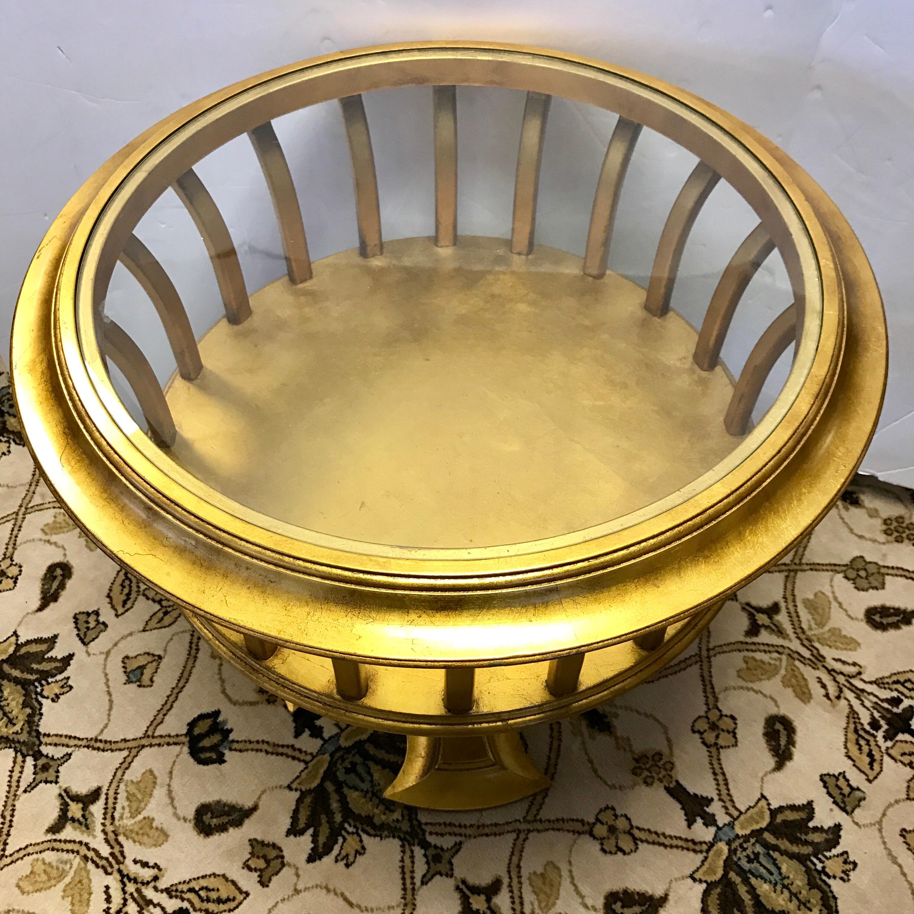 Round giltwood and glass table has a cage design. Display or store items inside the slatted sides. Glass top pops off if needed.