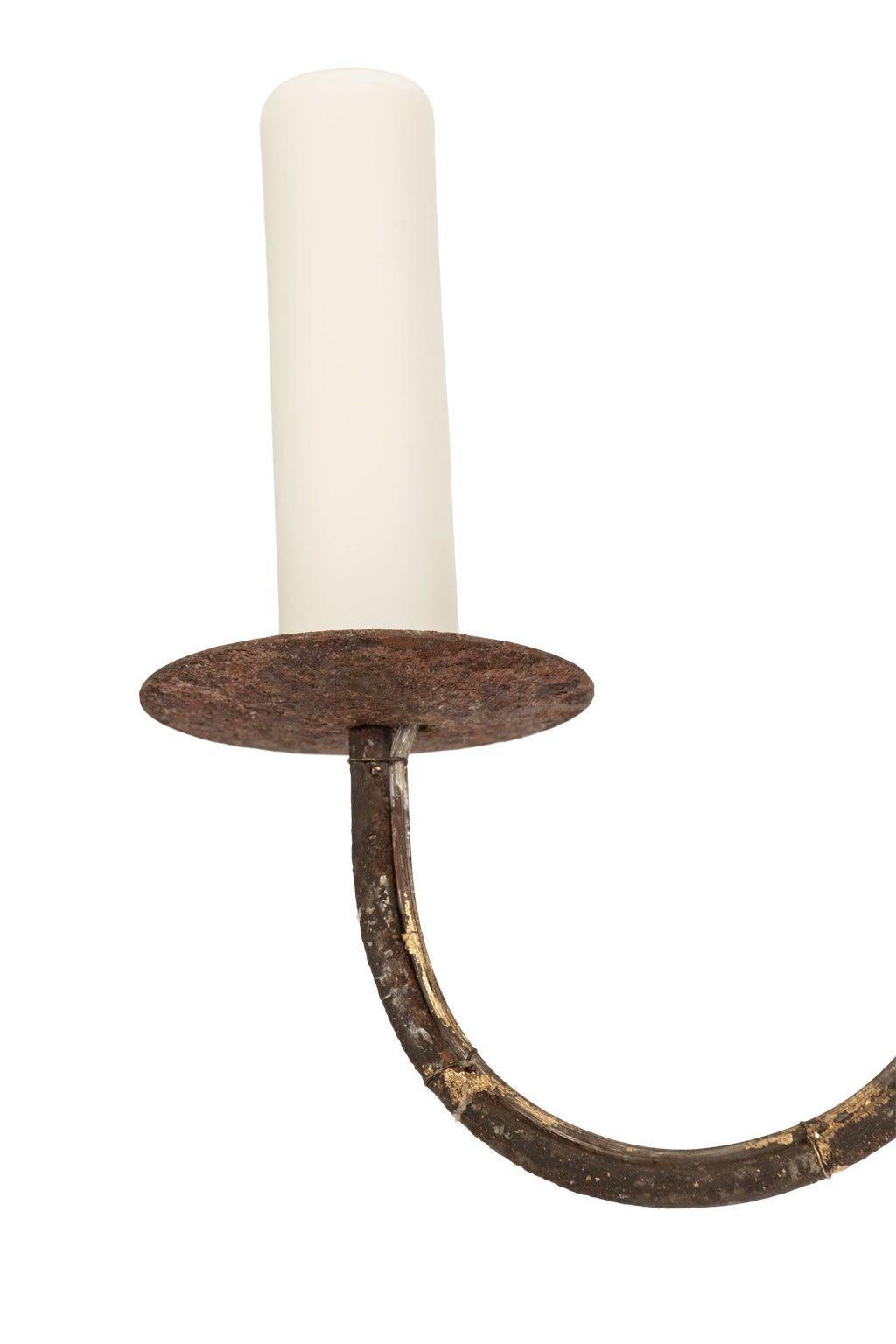 Italian giltwood and iron six-arm chandelier, newly created from 18th century and later elements. Hand-carved water gilded body with six iron arms covered in remnants of gilt. Newly-wired for use within the USA. Six candelabra-size sockets. Includes