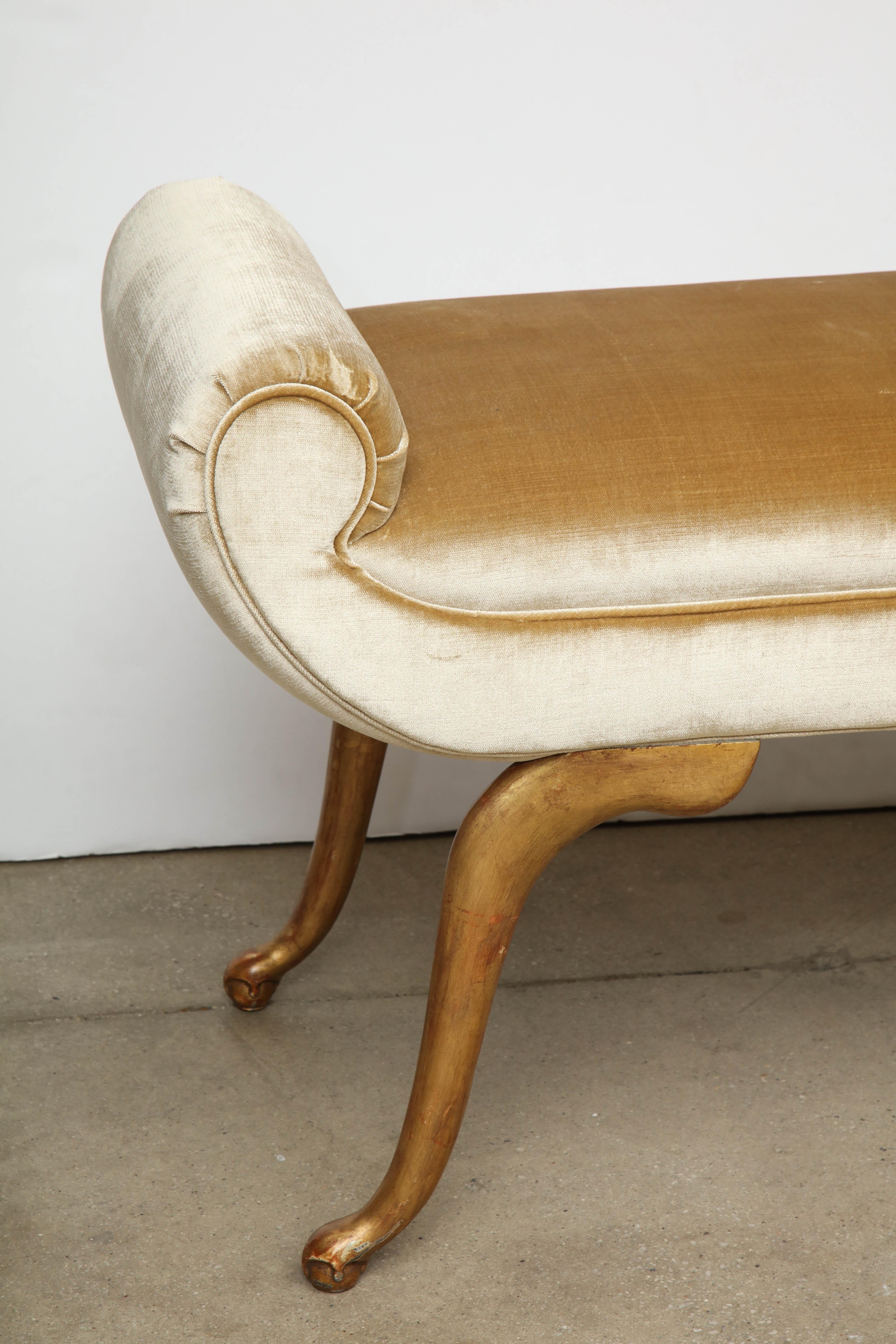 A glamorous Italian midcentury bench with asymmetrical scrolled ends on graceful, giltwood legs, covered in a silk velvet.