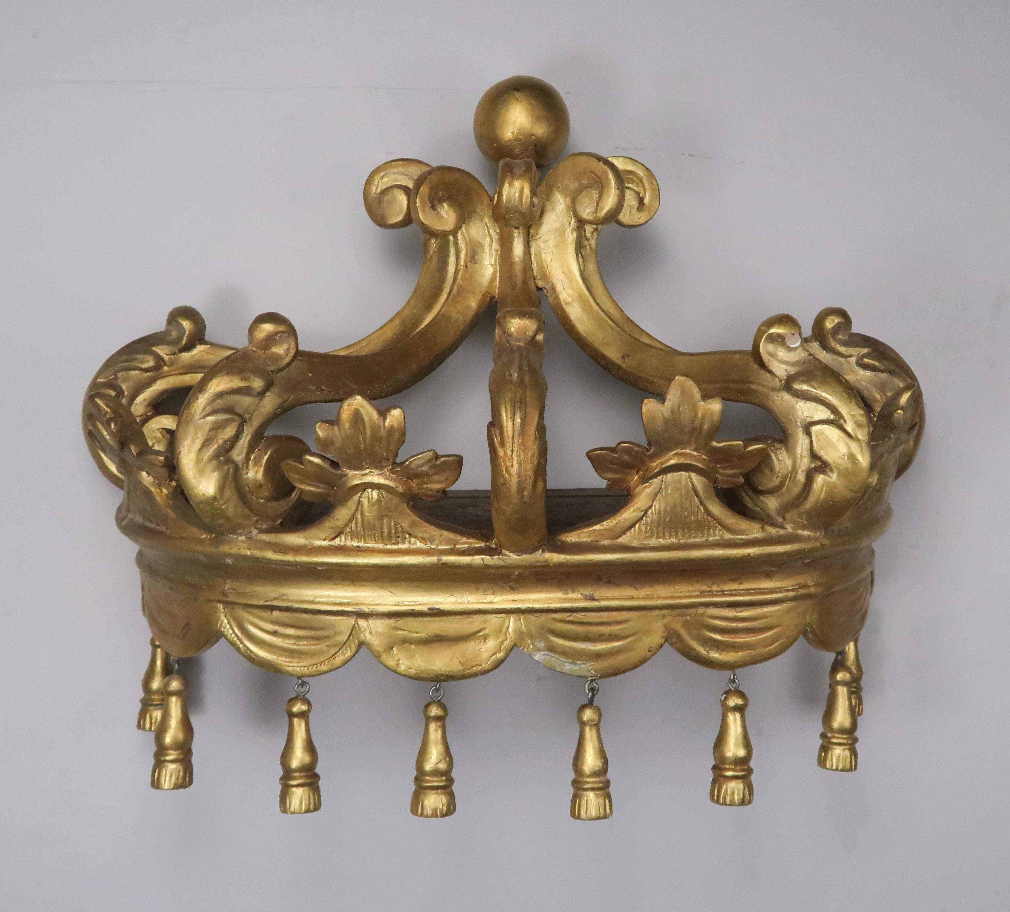 Italian gold leaf carved bed crown made with carved acanthus leaves and (8) hand-carved tassels hanging from the bottom. It can be hung over a bed or doorway to a room. You can drape fabric for a more dramatic effect.