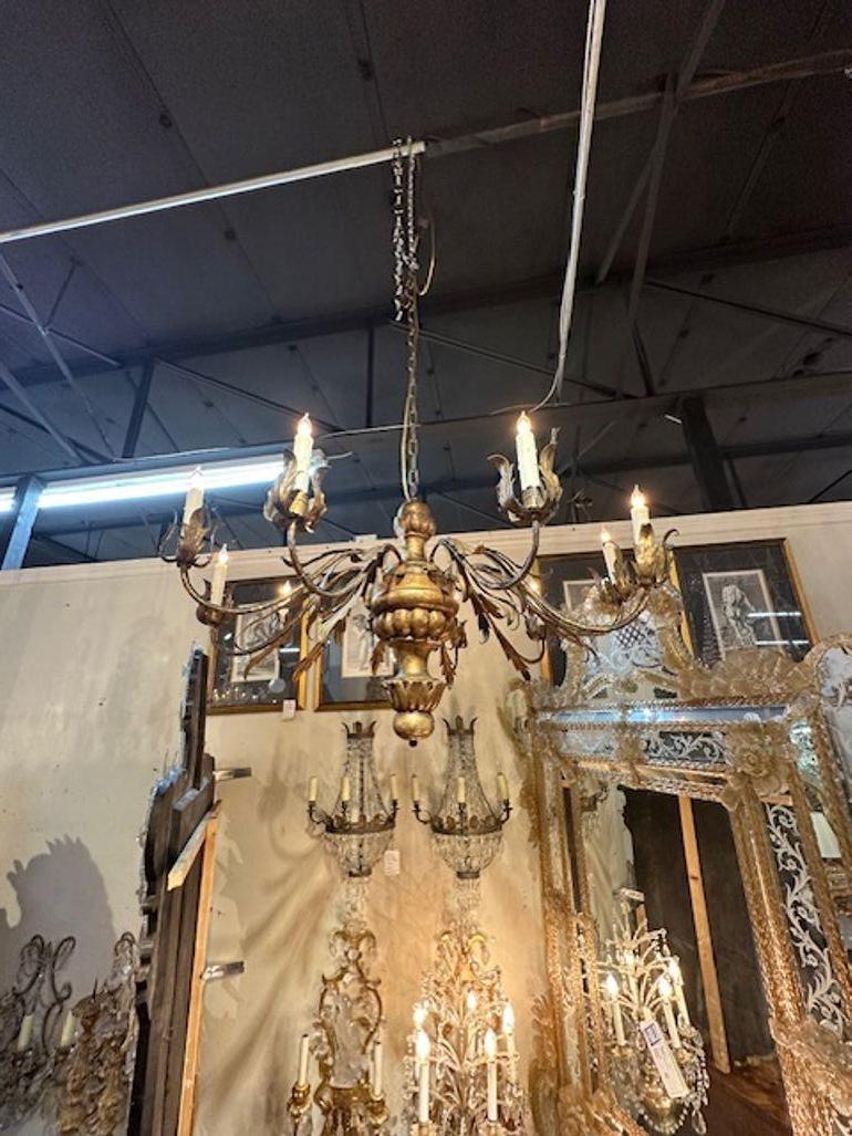 18th century Italian carved and giltwood 10-light chandelier. Circa 1780. The chandelier has been professionally rewired, comes with matching chain and canopy. It is ready to hang!