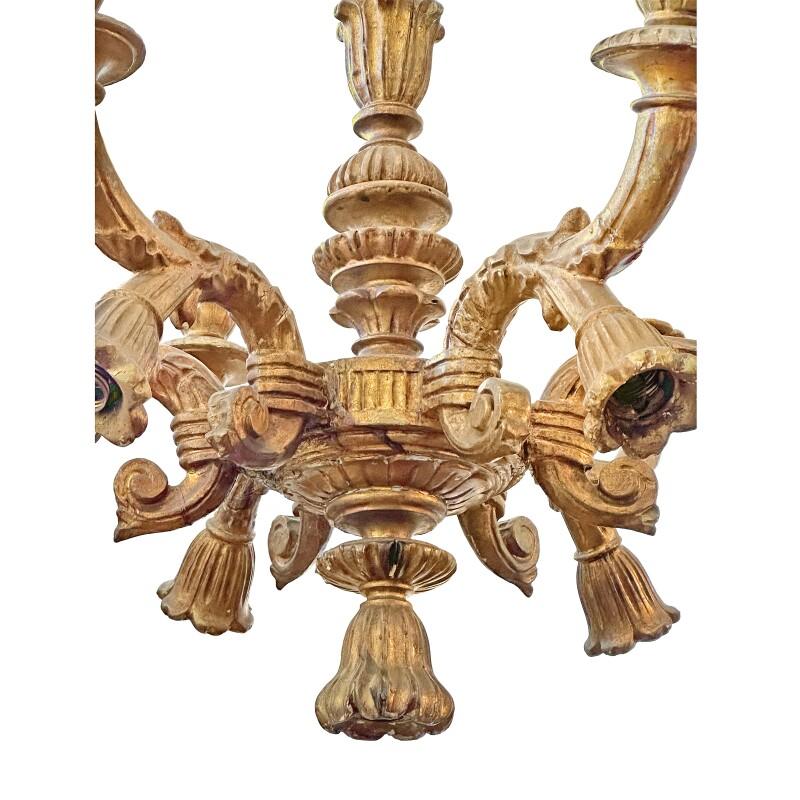 Turned vasiform fluted standard issuing a six-leaf carved candle arms with waisted above a lobed pendant.