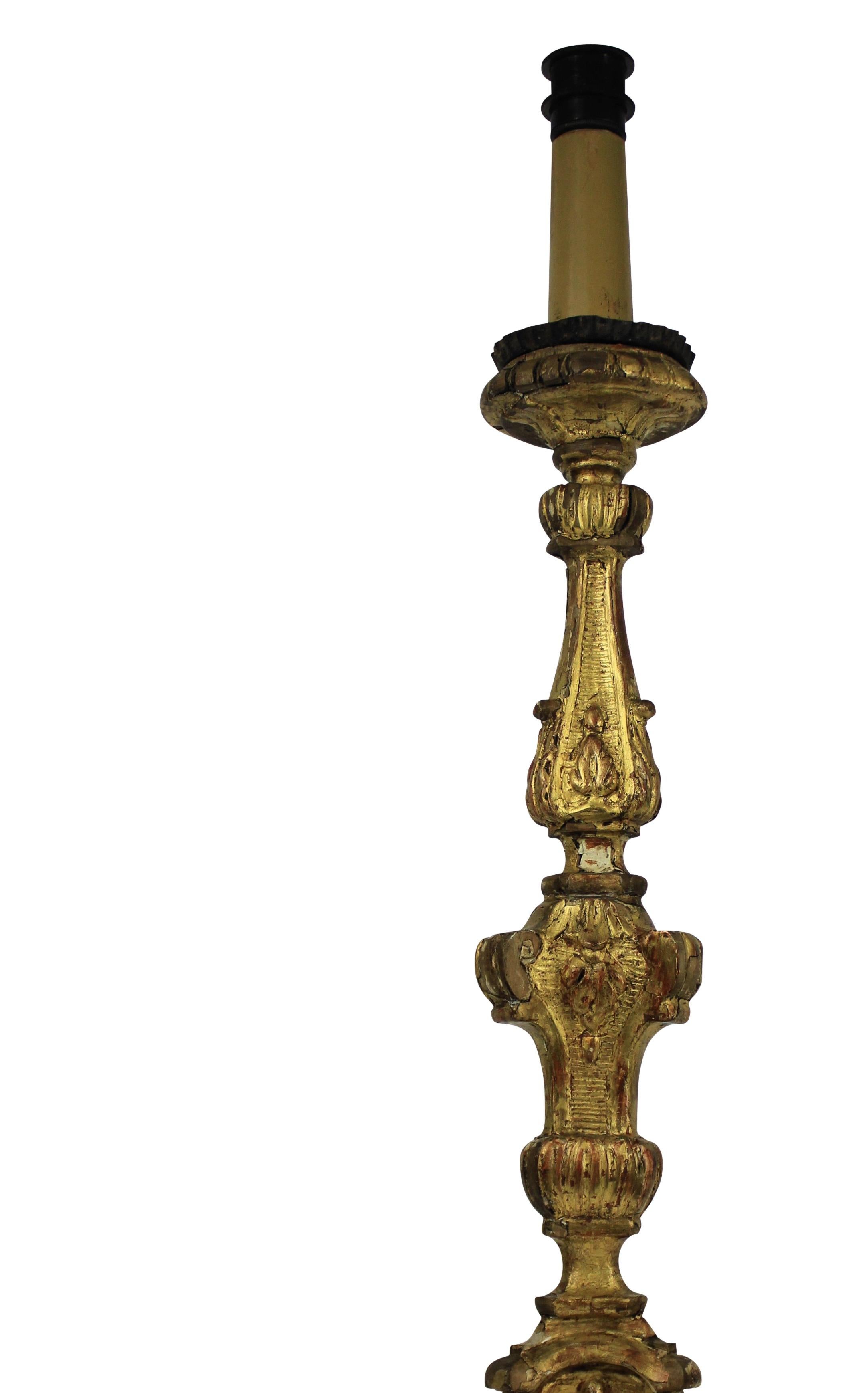 An Italian carved and water gilded Baroque candlestick now converted into a lamp.

 