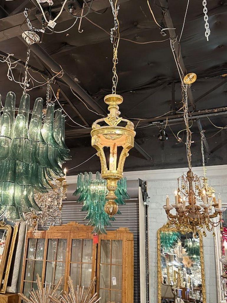 19th century Italian carved and giltwood lantern. Circa 1880. The chandelier has been professionally rewired, comes with matching chain and canopy. It is ready to hang!