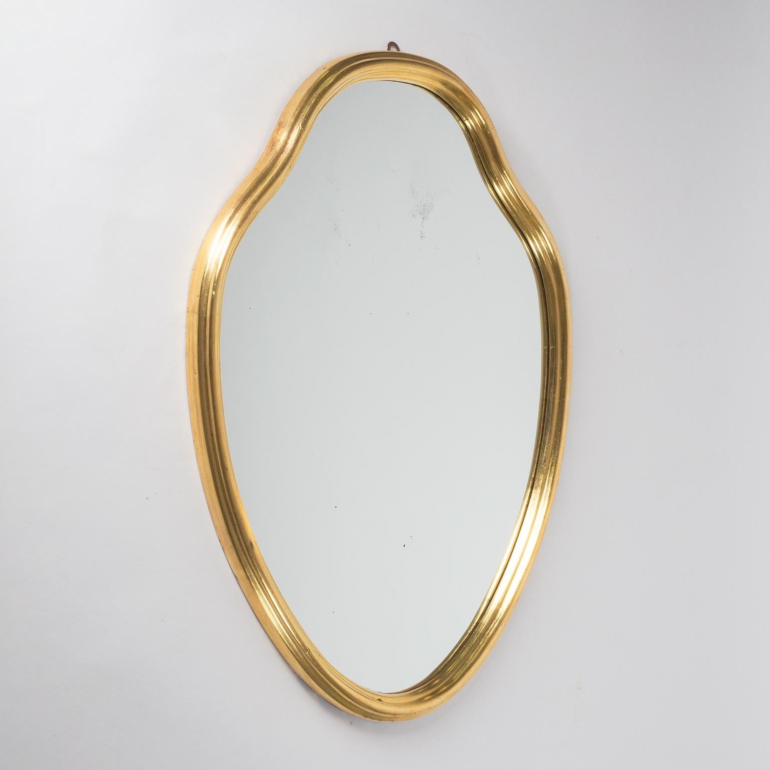 Rare Italian giltwood mirror from the 1940s. Very nicely profiled carved wood frame with leaf gold. Fine original condition with minor wear due dryess of the wood and some loss of gilding at the bottom edge. Original silvered mirror with some