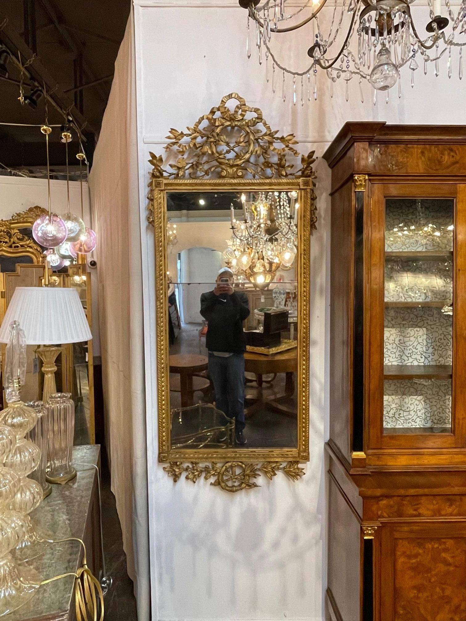 18th century Italian carved and giltwood mirror with original divided mercury glass, Circa 1780. This is a fine quality mirror that is sure to make a statement.