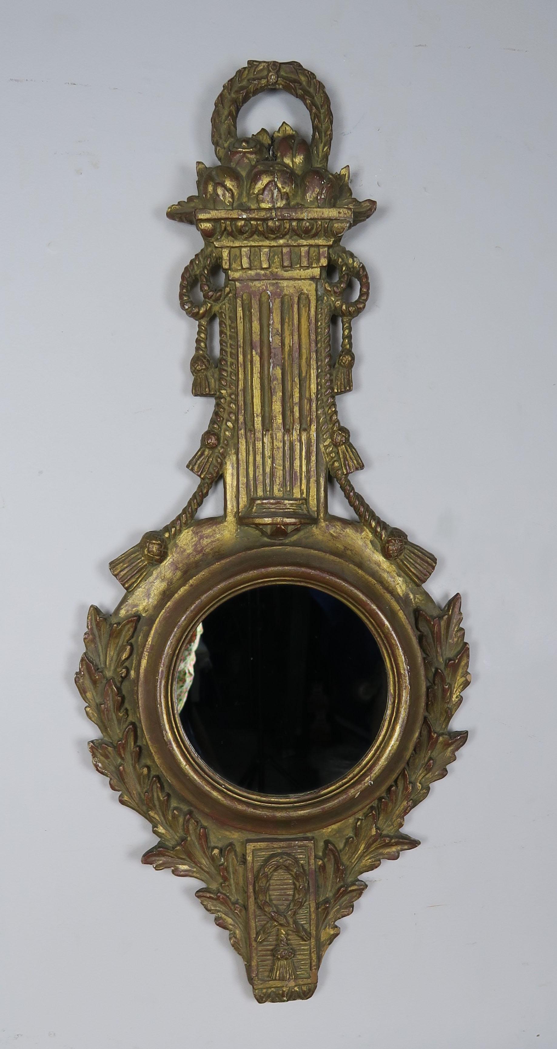 Italian giltwood mirror adorned with carved tassels and laurel leaves. Marked 